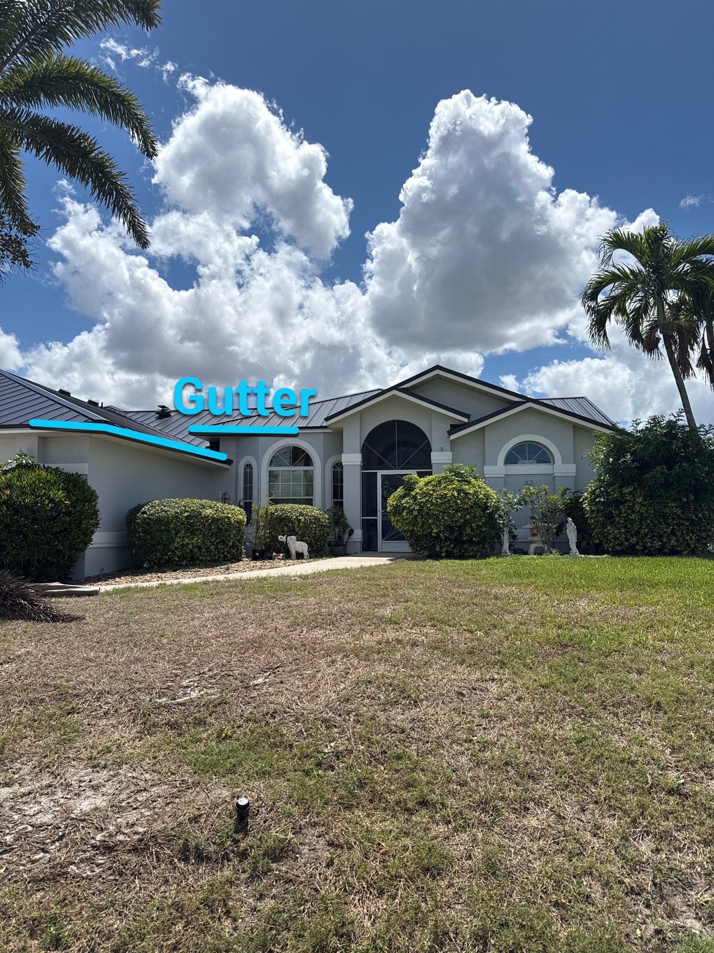 Black Seamless Gutters and White Downspouts in Cape Coral FL by Gutter Professors