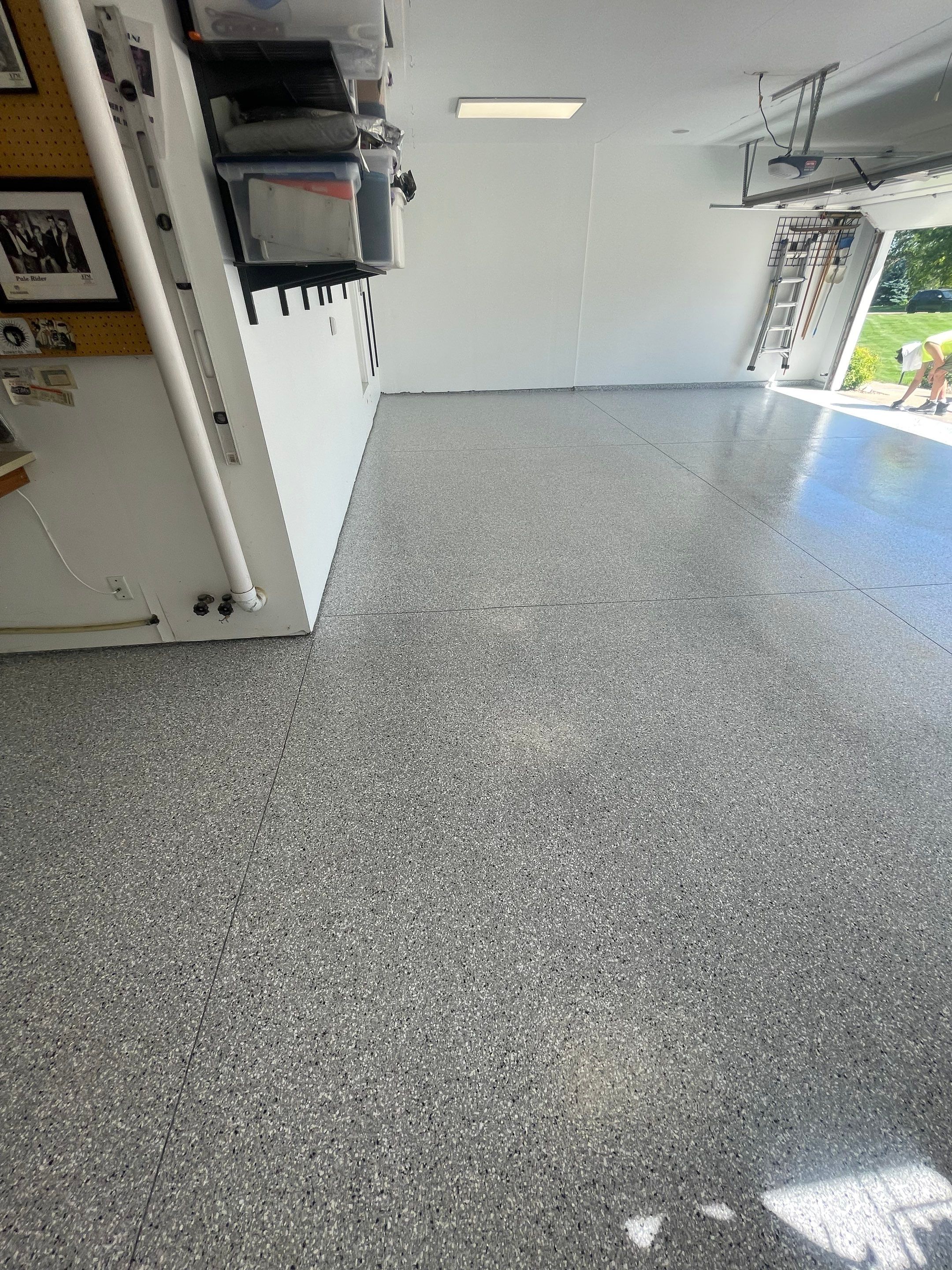 Feather Grey Garage Floor Coating Installation in Sioux Falls by Select Painting, Coatings & Garage Cabinets