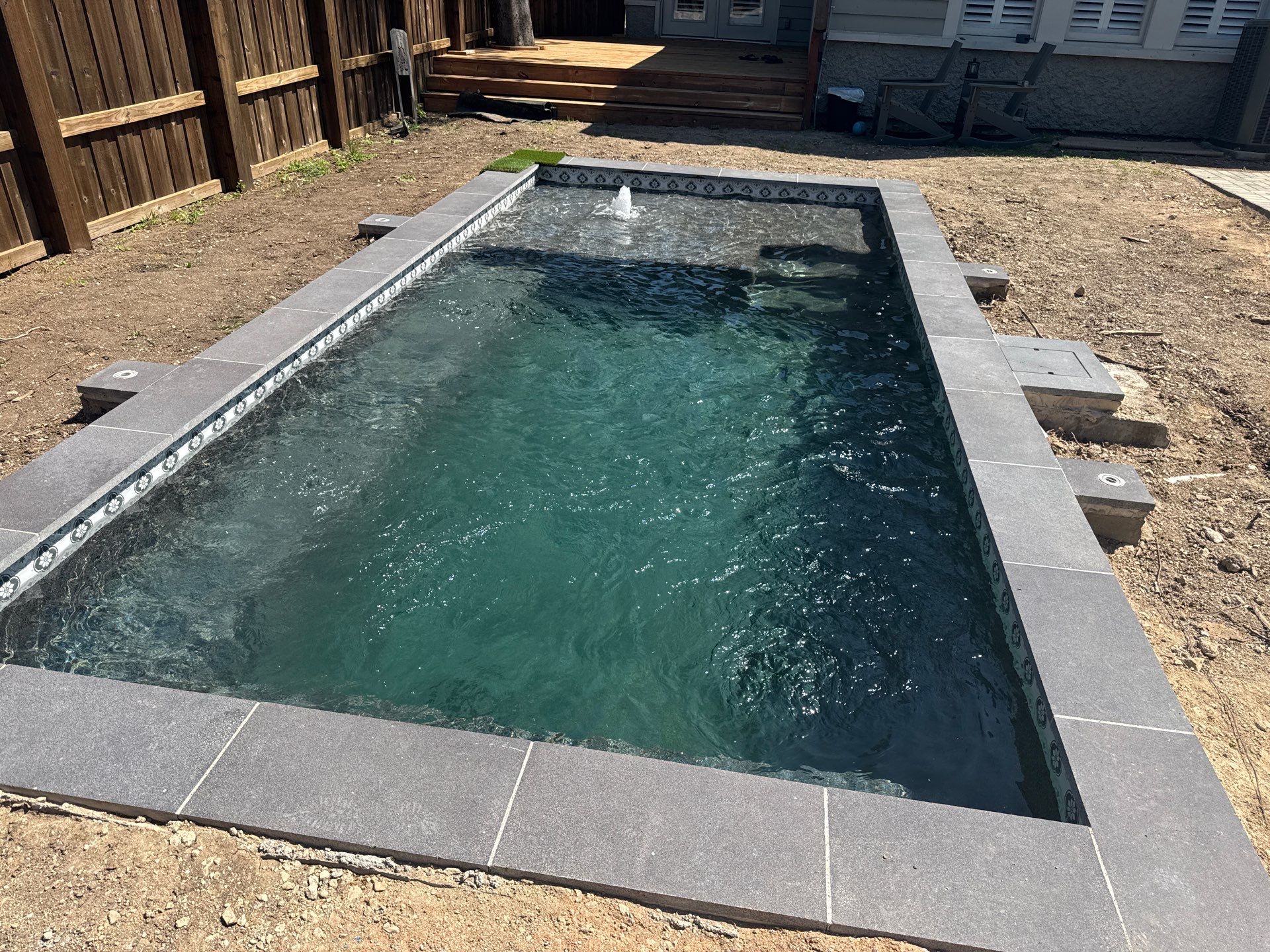 Modern Plunge Pool with Dark Interior and Paver Patio by Pinnacle Pools and Spas - DFW