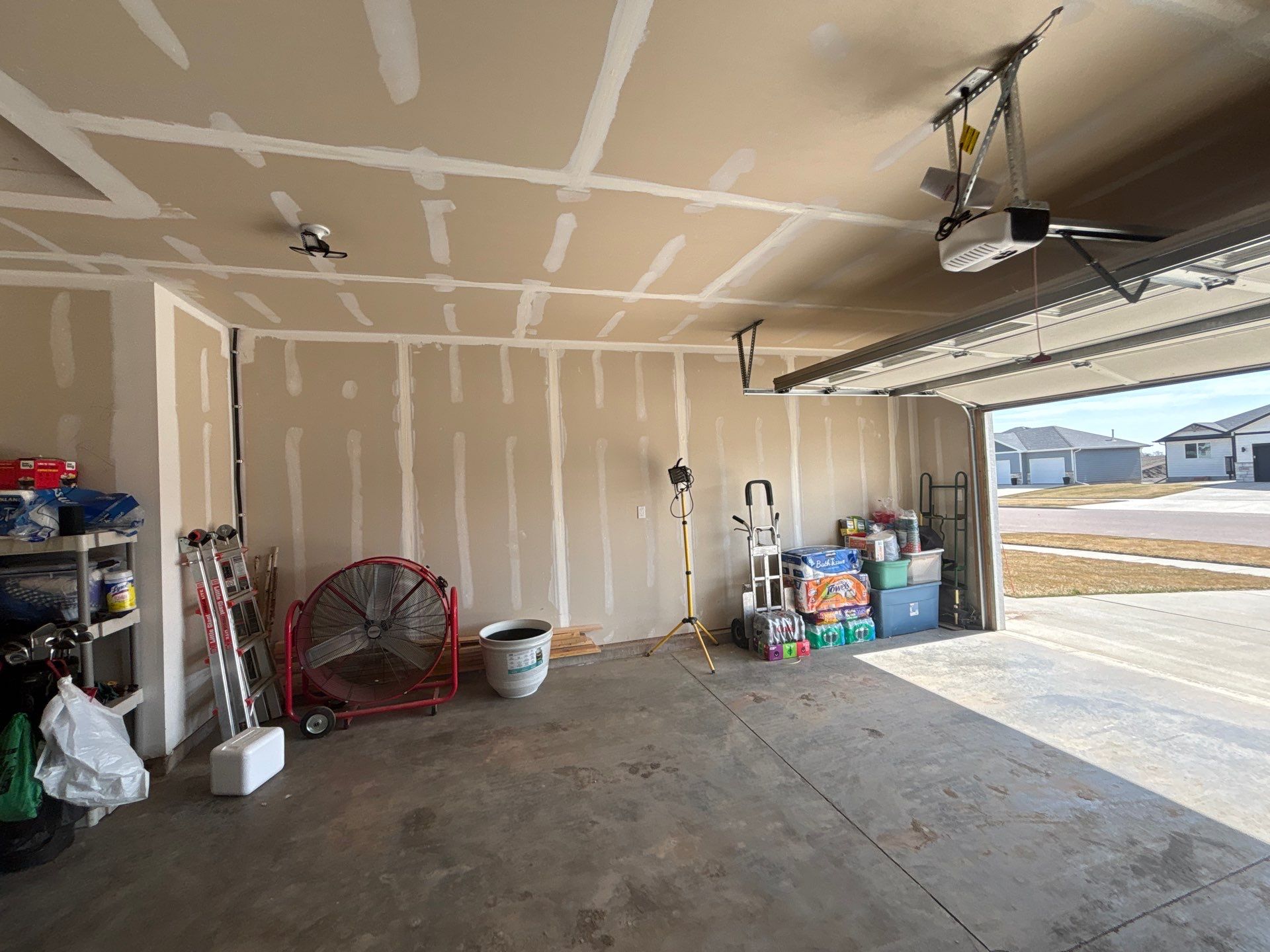 Grey Flake Epoxy Garage Floor Coating in Sioux Falls by Select Painting, Coatings & Garage Cabinets