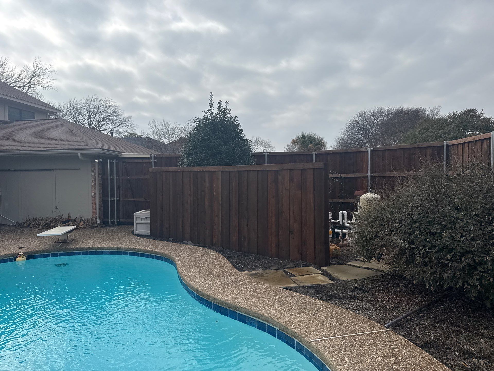 Pre-Stained board on board w/ trim and kickboard using 1x4 cedar trim by Grizzly Fence And Patio