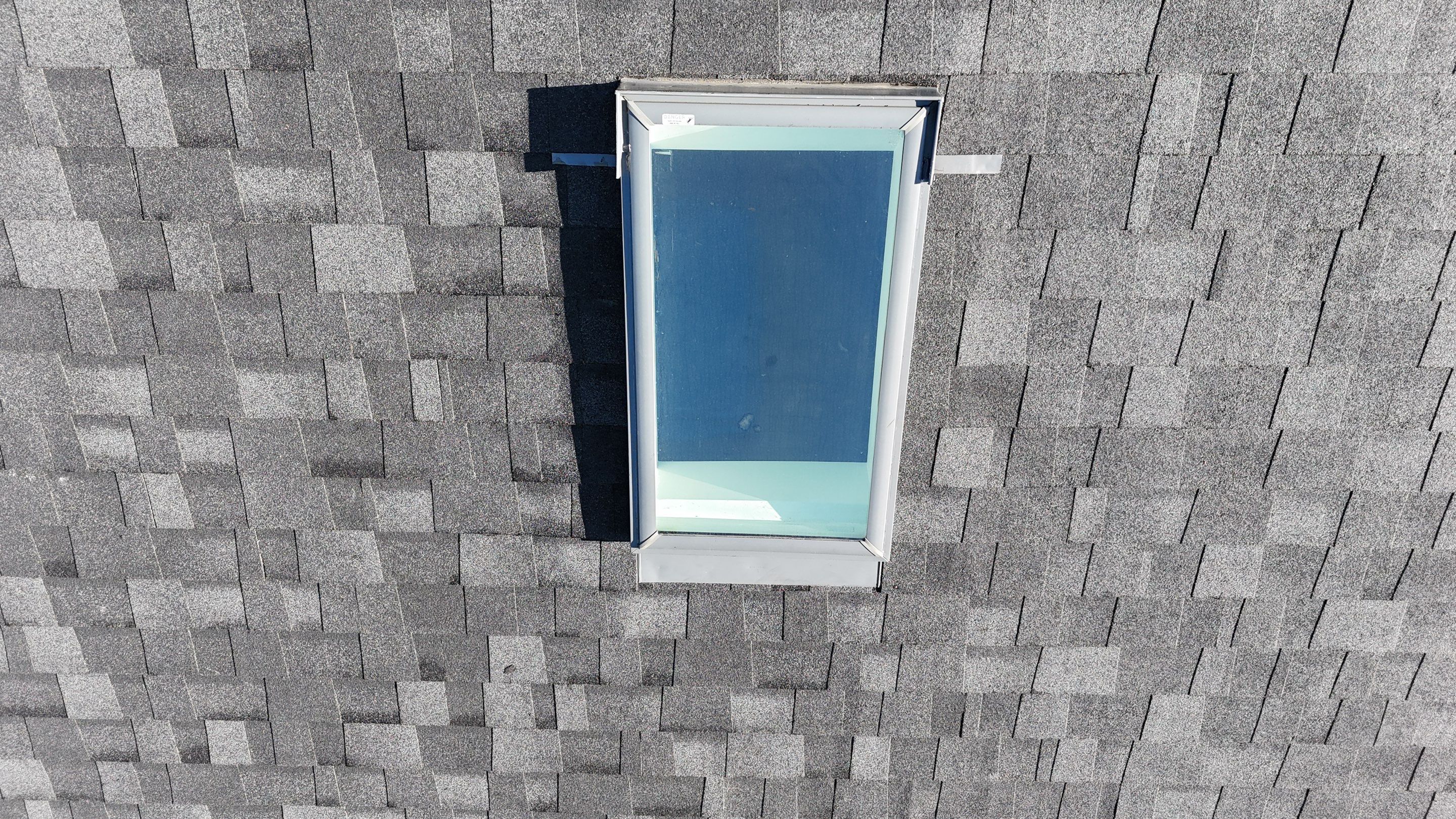 Roof Replacement with Skylight Flashing in Waltham, MA by Mighty Dog Roofing of Greater Middlesex County
