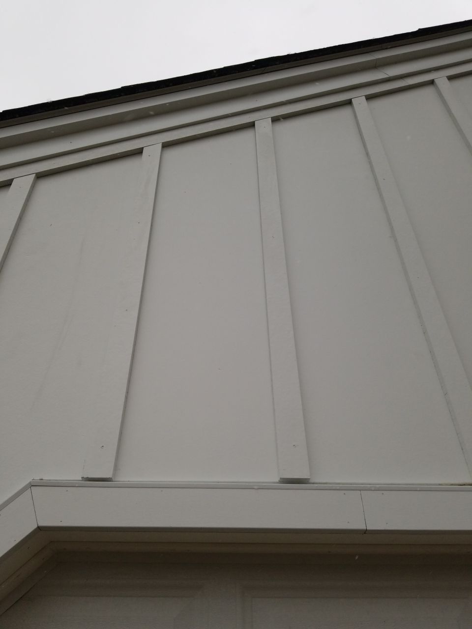 James Hardie Siding  using James Hardie Board and Batten, White by Absolute Roofing and Construction