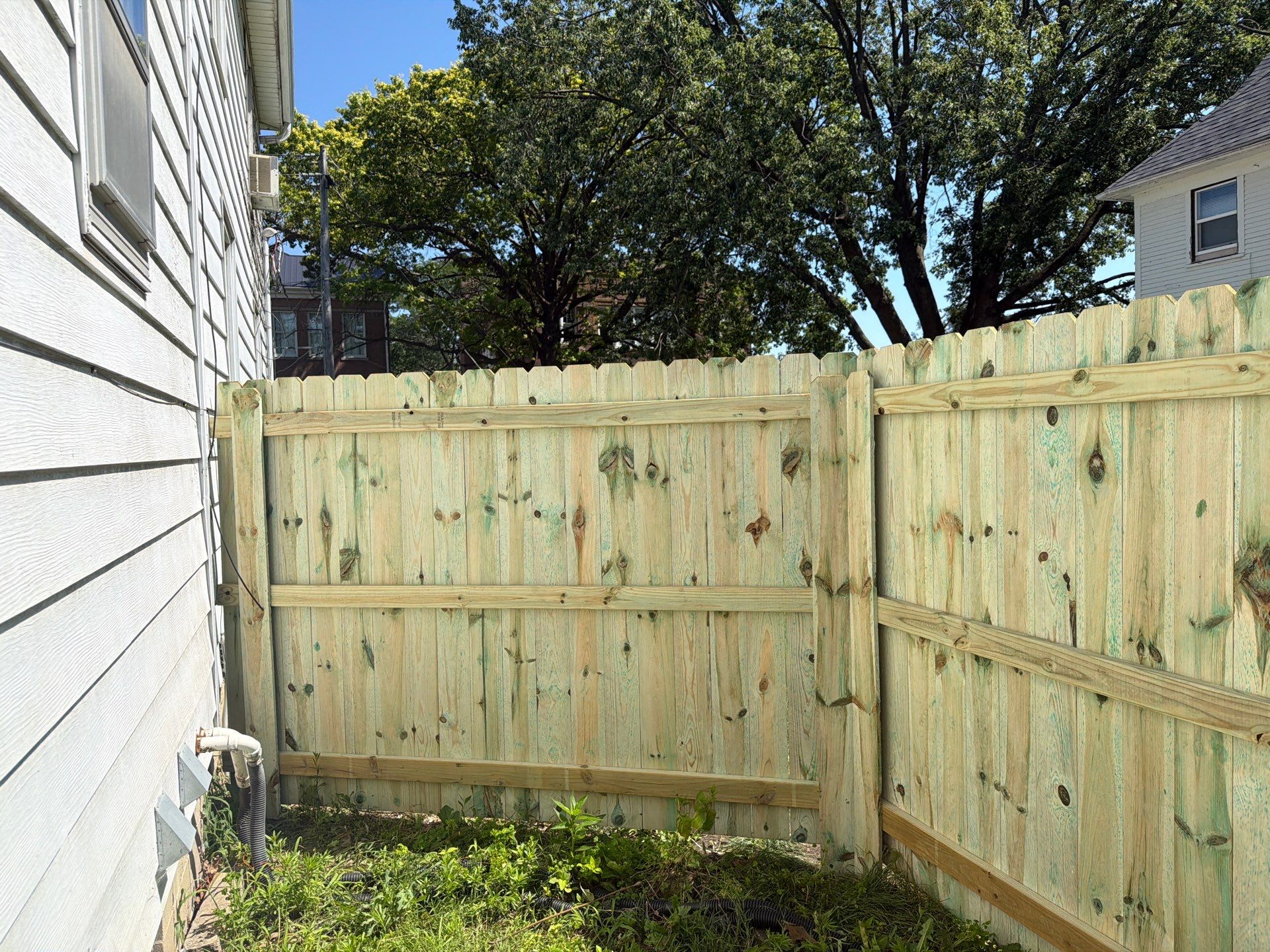 Pressure-Treated Wood Privacy Fence Installation in Waterloo by Perfect Picket Fence and Stain