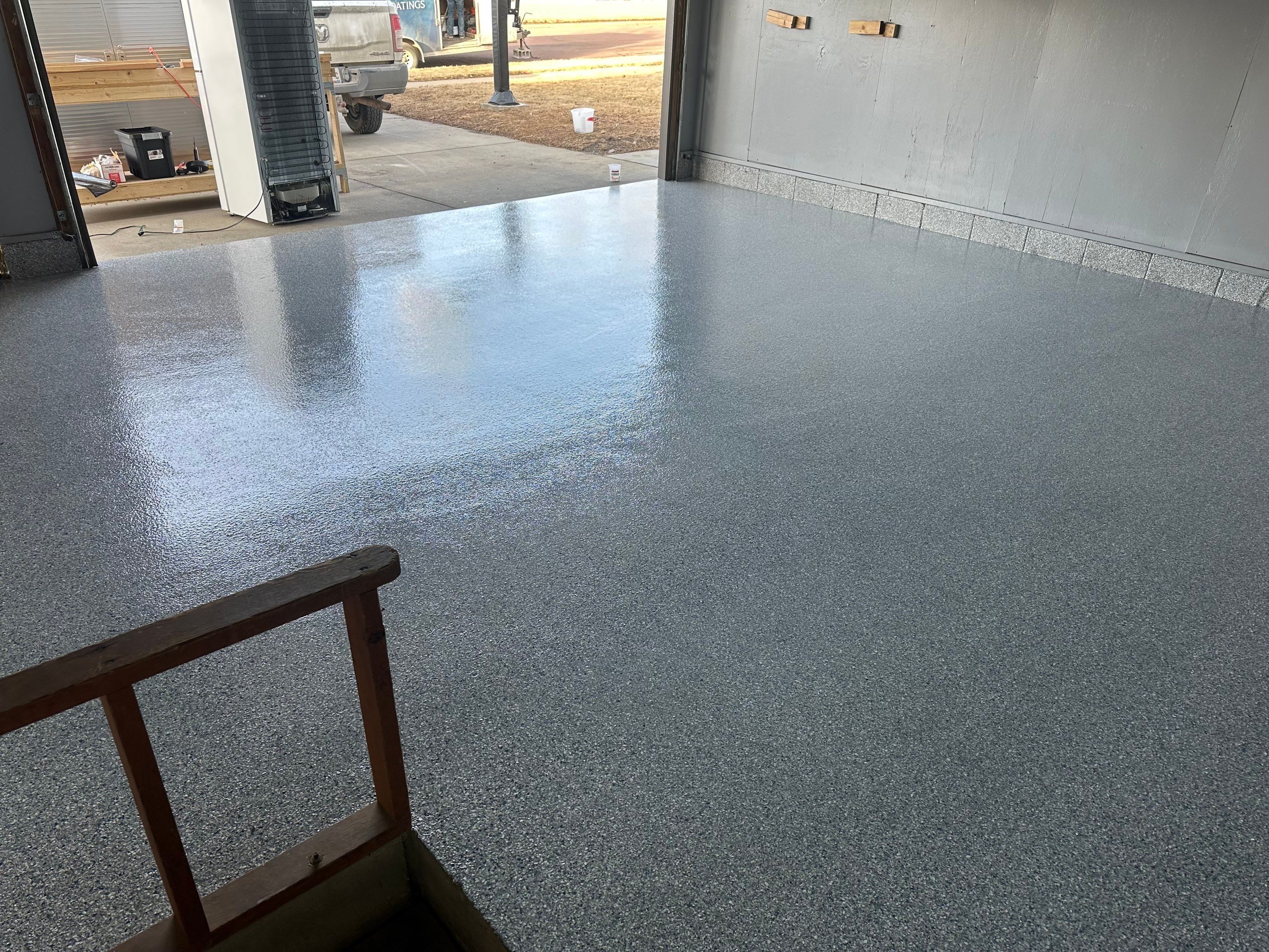 Multi-Colored Speckled Concrete Floor Coating Installation in Sioux Falls by Select Painting, Coatings & Garage Cabinets