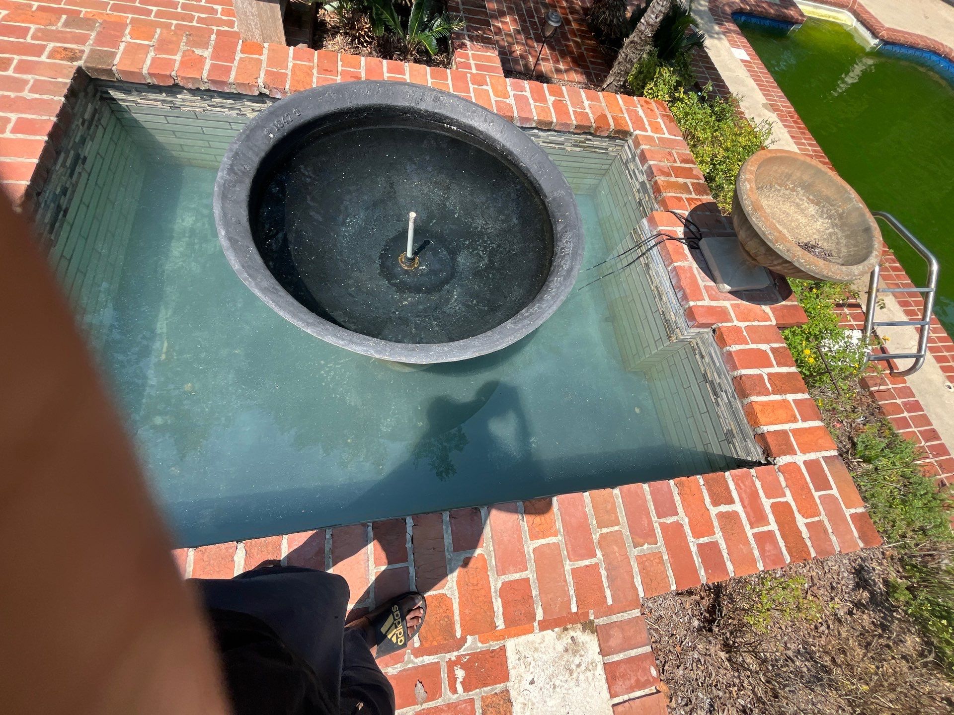 Pool Cleaning using Pool Cleaner by College Bros Outdoor services