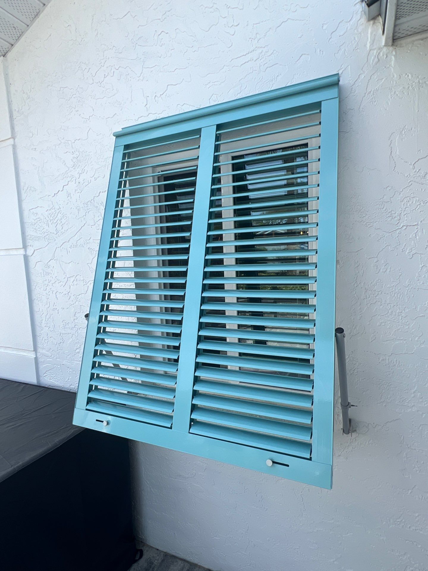 Hurricane Rated Bahama Shutters in Pastel Turquoise  by Smart Guard Shutters
