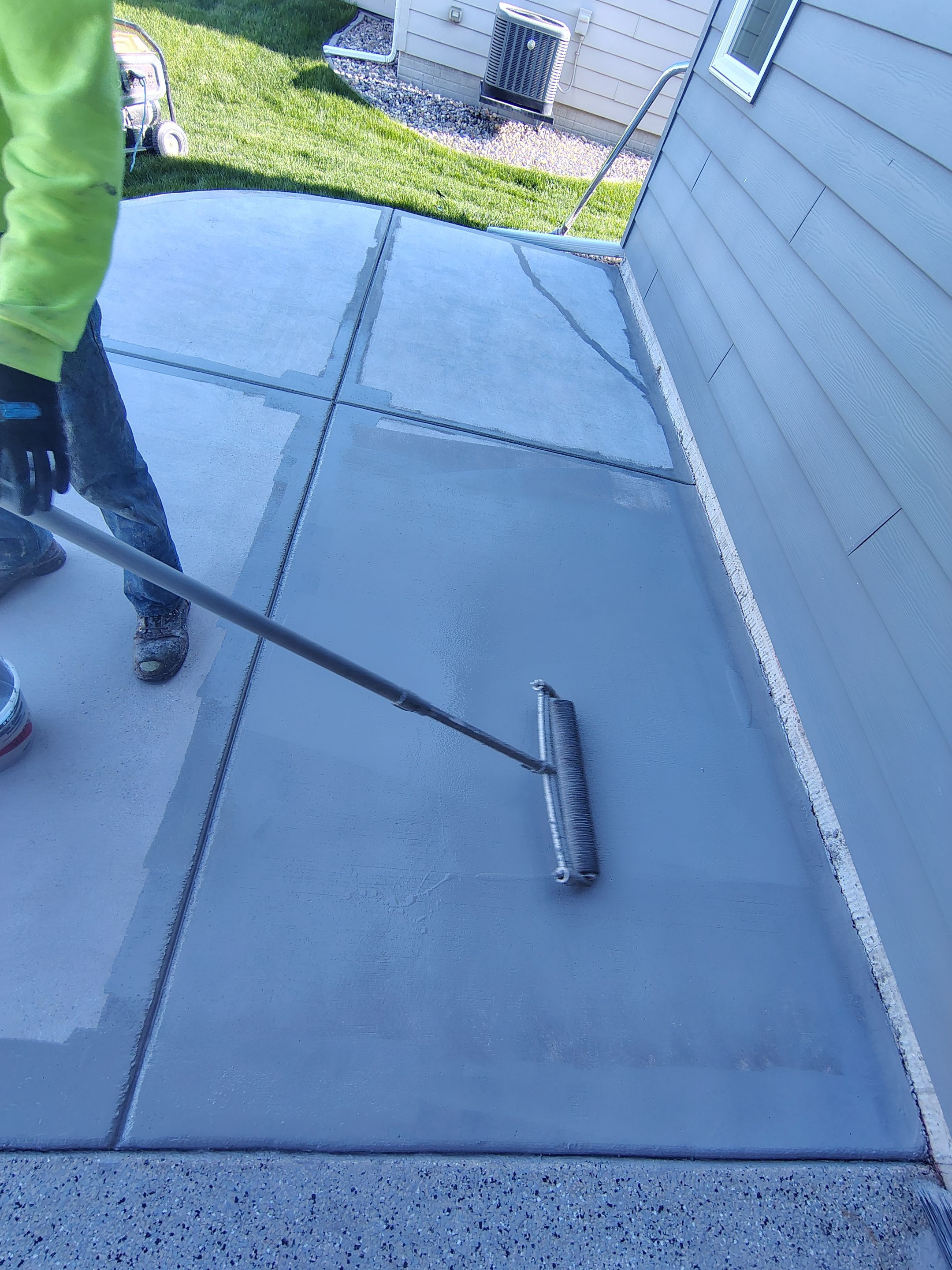 Speckled Concrete Patio Coating Installation in Sioux Falls by Select Painting, Coatings & Garage Cabinets