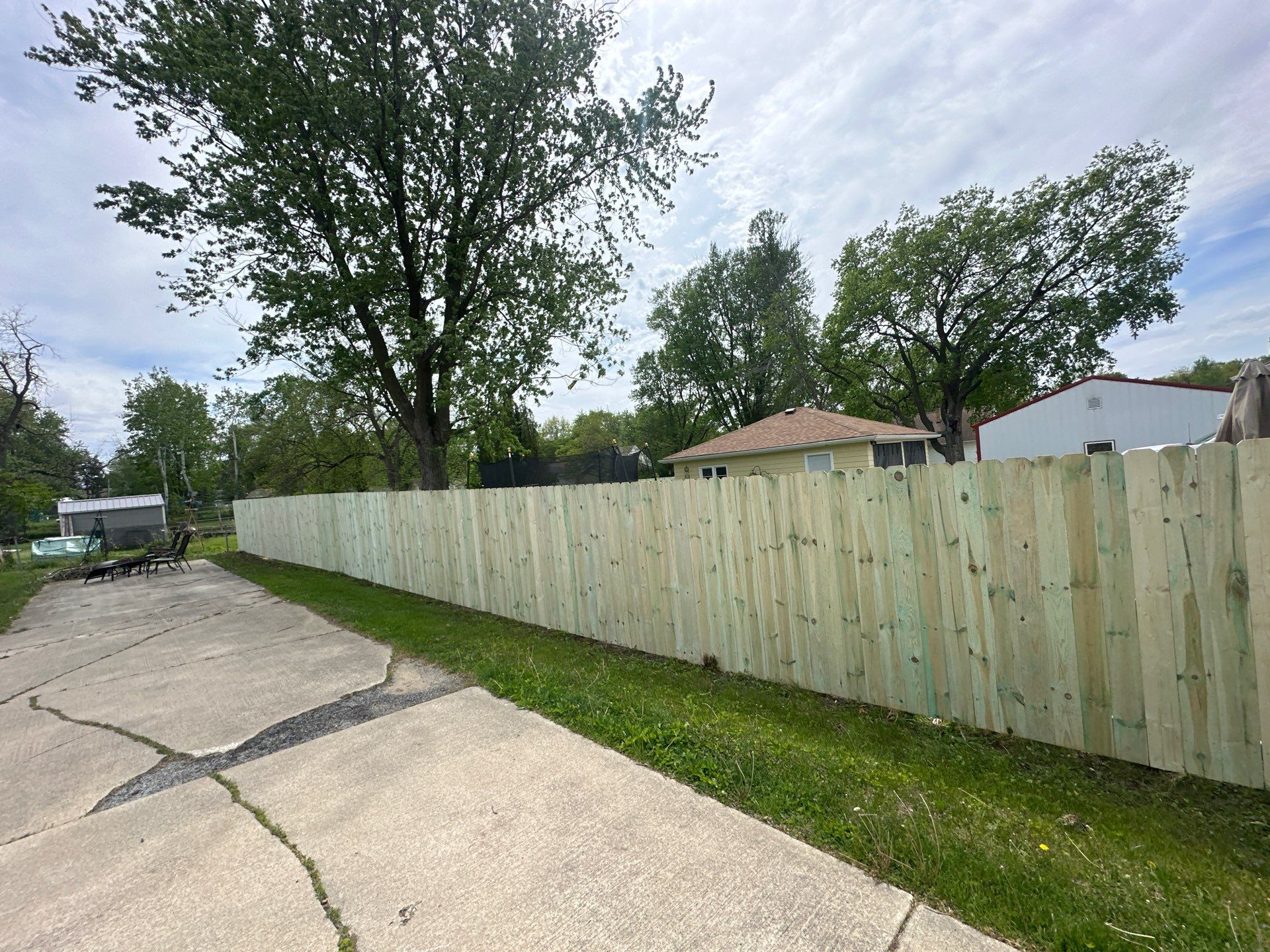 Pressure-Treated Wood Privacy Fence Installation in Waterloo by Perfect Picket Fence and Stain
