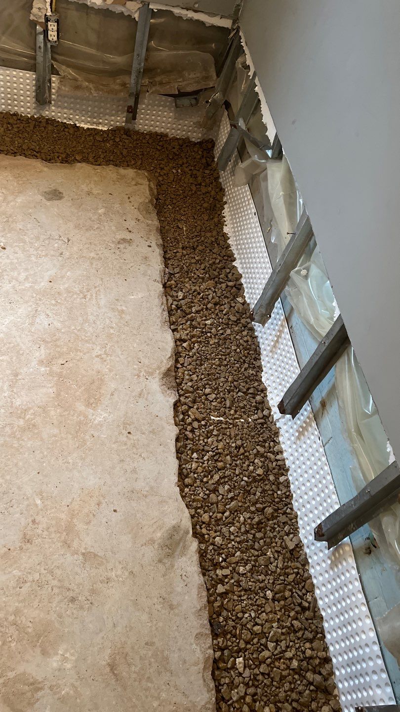 Interior drain tile system installation by ACE Waterproofing & Basement Solutions