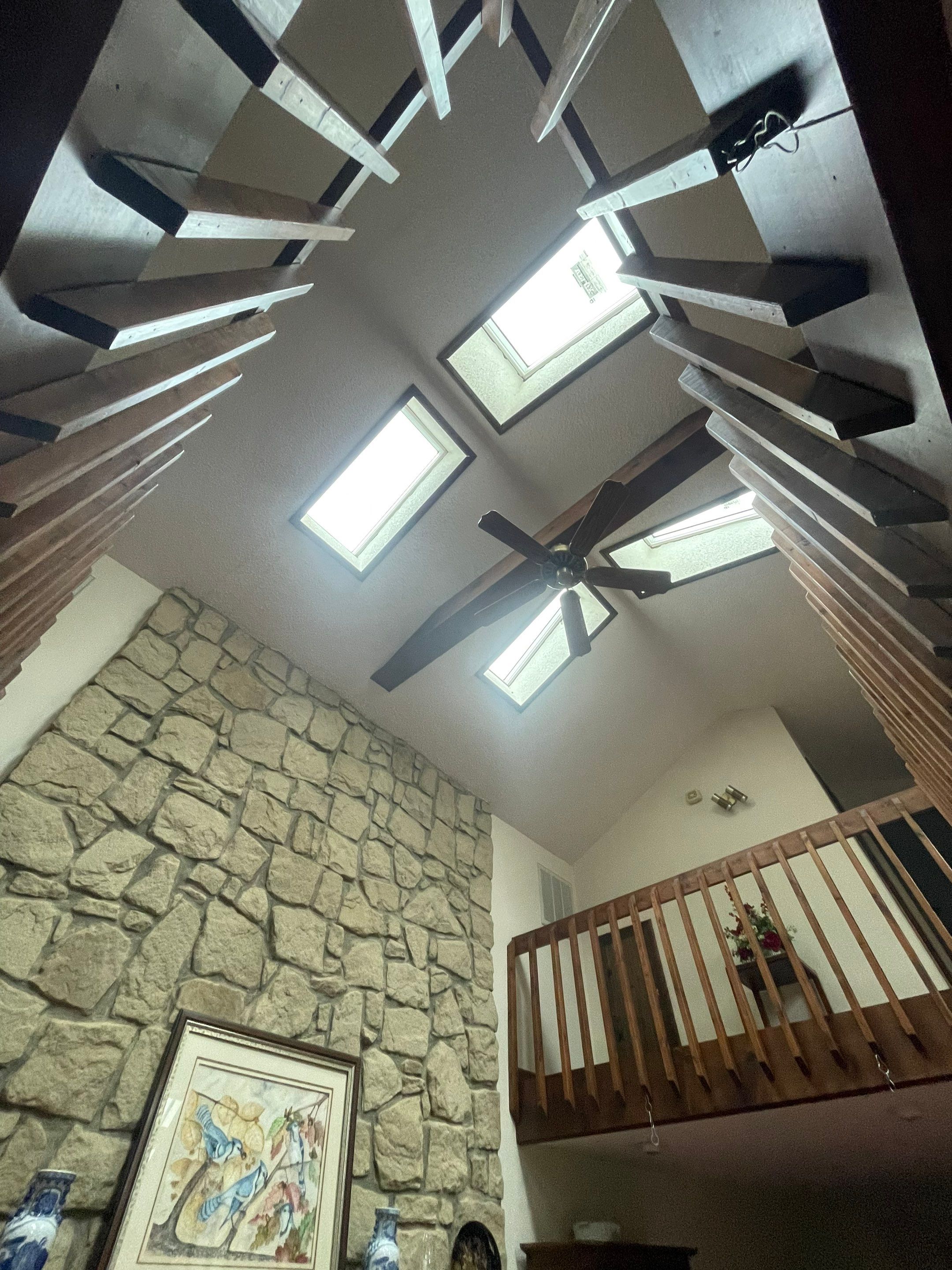 Shingle Roofing with Velux Skylight replacement and stone chimney flashing  by Secure Construction Company Inc