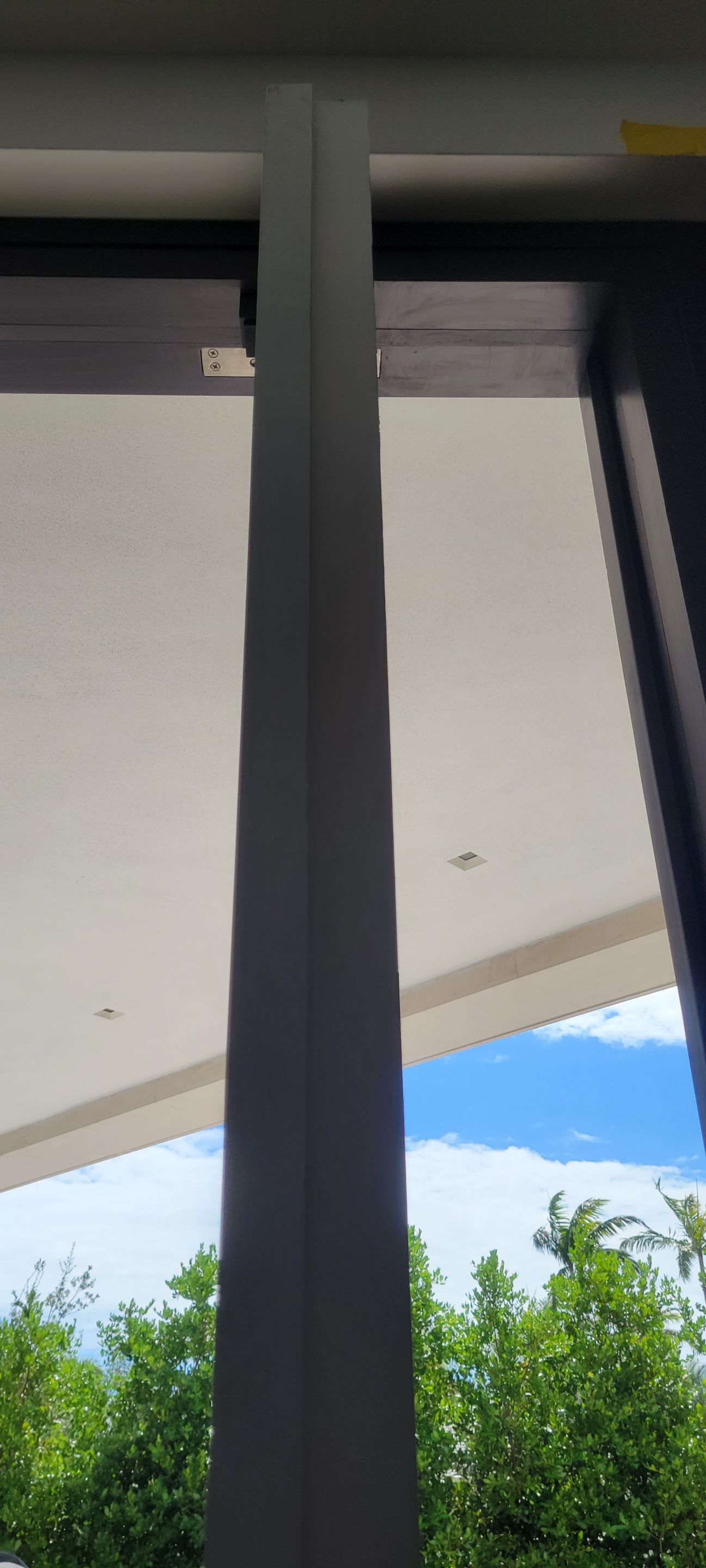 Custom Material Pivot Door installation by Impact Precious Wood Inc.