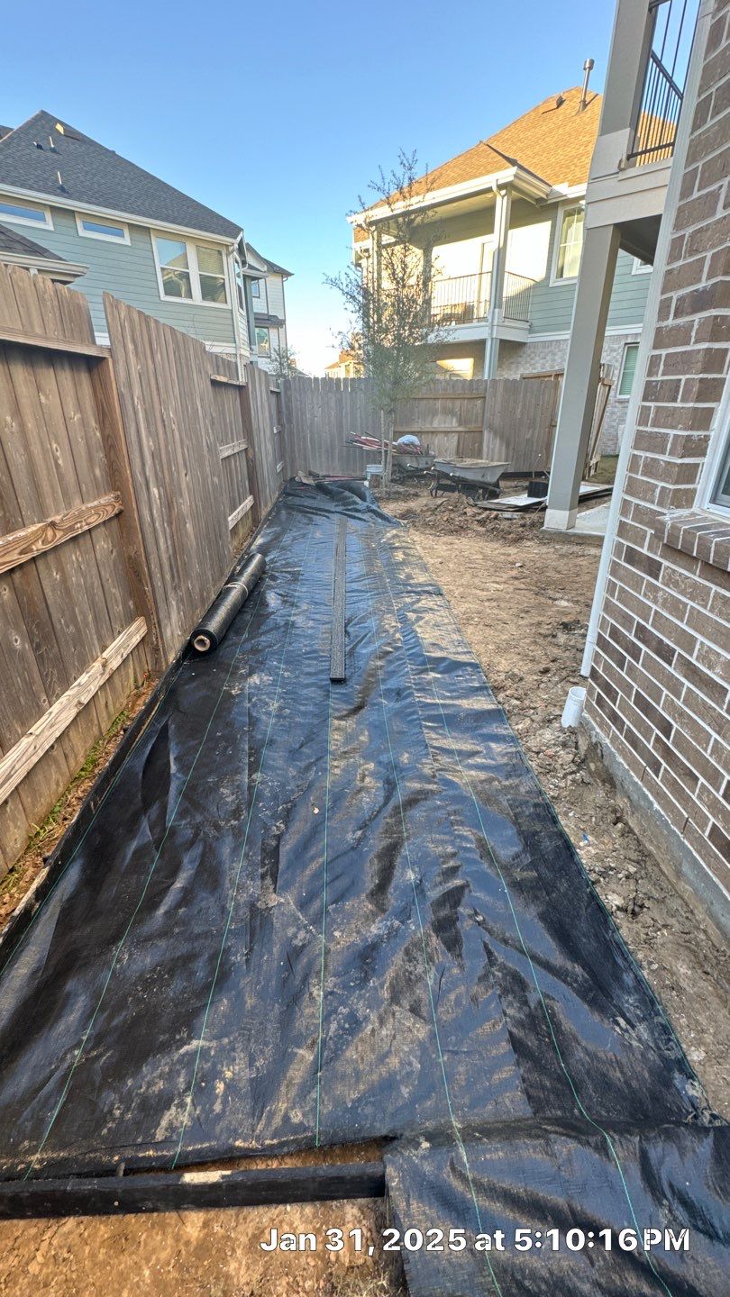 🌿💧 Mary Anne’s Backyard Upgrade – Drainage & Gravel Solution  Every great outdoor space starts with a strong foundation—and for Mary Anne, that meant tackling her backyard drainage challenges first.  Our team stepped in to improve the current drainage system, ensuring stormwater flows naturally away from the foundation. This not only protects the property but also sets the stage for a long-lasting, low-maintenance backyard.  Once the flow was under control, we moved on to creating a new gravel area, complete with fresh leveling, grading, and compaction. By combining proper drainage with durable materials, we built a space that’s as functional as it is clean and polished.  🛠 Project Highlights  Drainage Improvements – installed PVC system to redirect water and prevent pooling.  Gravel Installation – black star gravel compacted over weed blocker for strength and beauty.  Paver Additions – functional stepping areas designed for both style and convenience.  Material Upgrades – premium weed blocker, bend-a-board edging, and drainage stacks.  ✅ Result: Mary Anne now enjoys a backyard that is secure, low-maintenance, and ready for future features like a fire pit or expanded patio.  💡 At Texas Urban Elements, Alejandro and his team of handcrafted specialists focus on long-term solutions—blending design, drainage, and durability into every project.  📢 Ready to protect your home while upgrading your outdoor space? Let’s design your solution today. by Texas Urban Elements