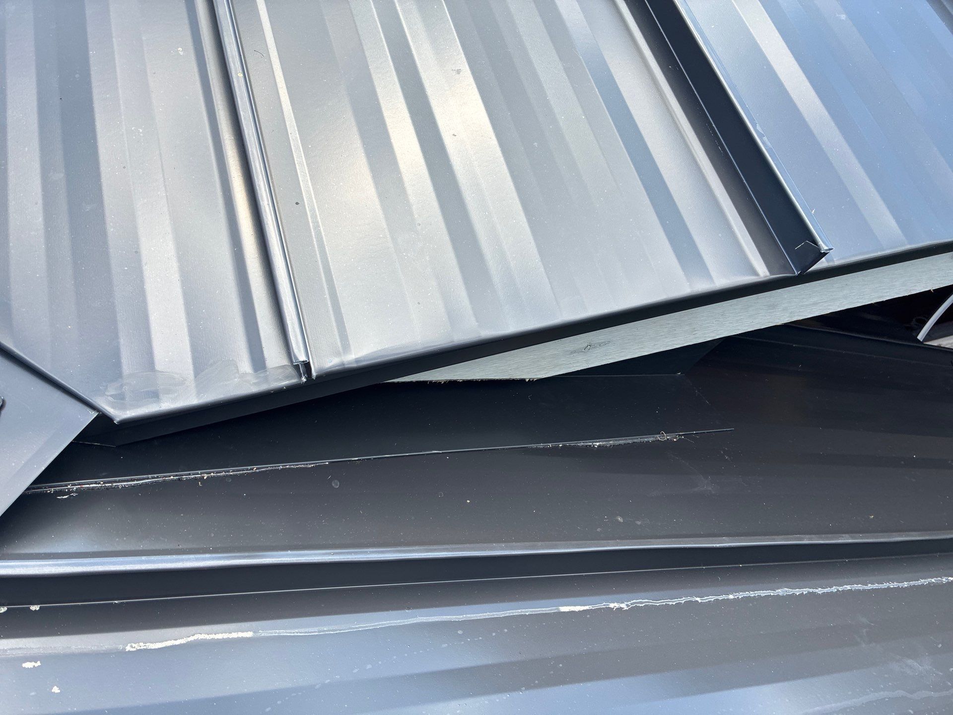 24ga 1.5" Mechanical Seam Matte Black by Total Roofing System The Metal Roof Experts