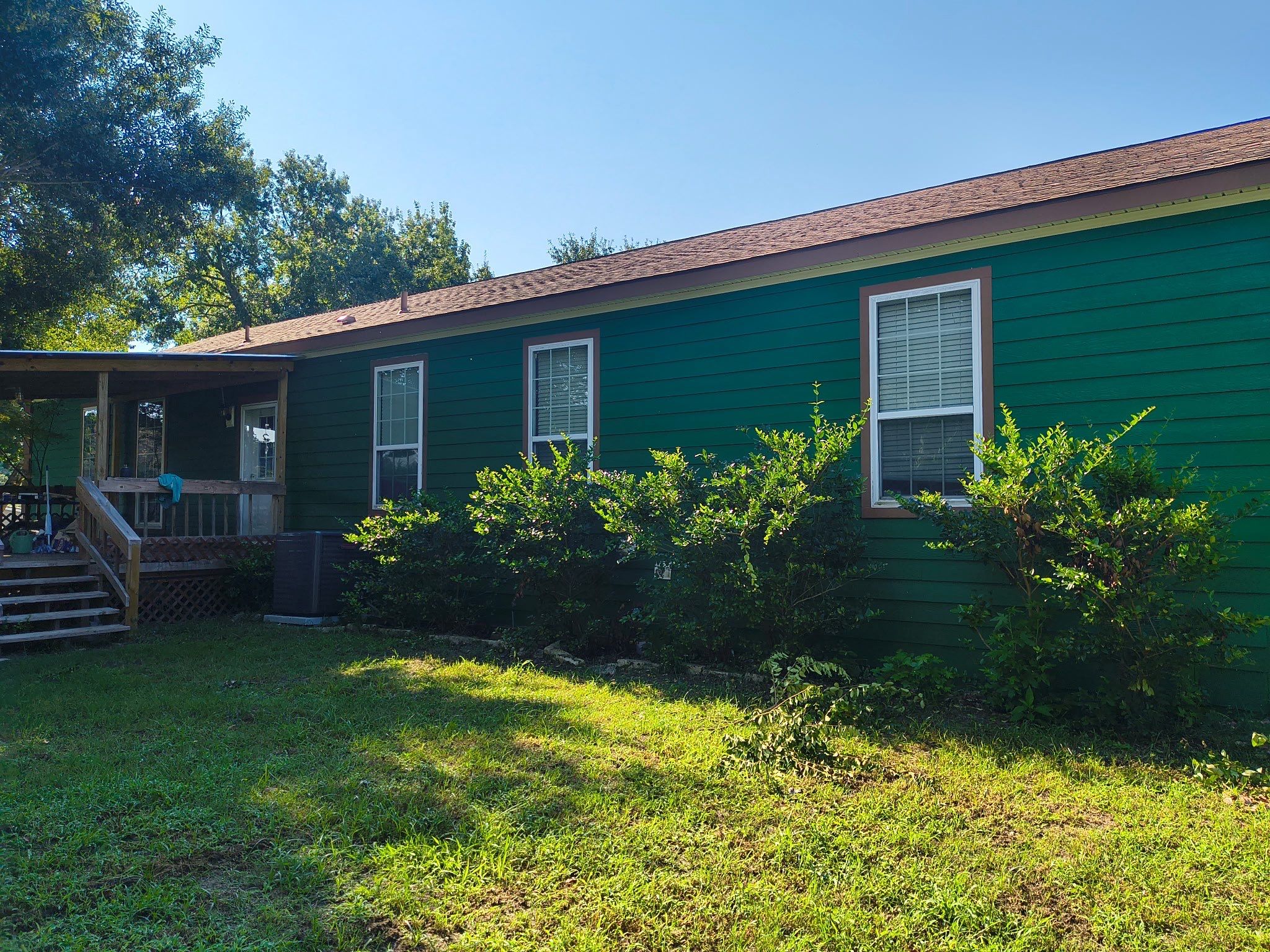 Exterior Painting in Lindale, TX | Bright Green Wood House Repaint by Quality Coats Painting