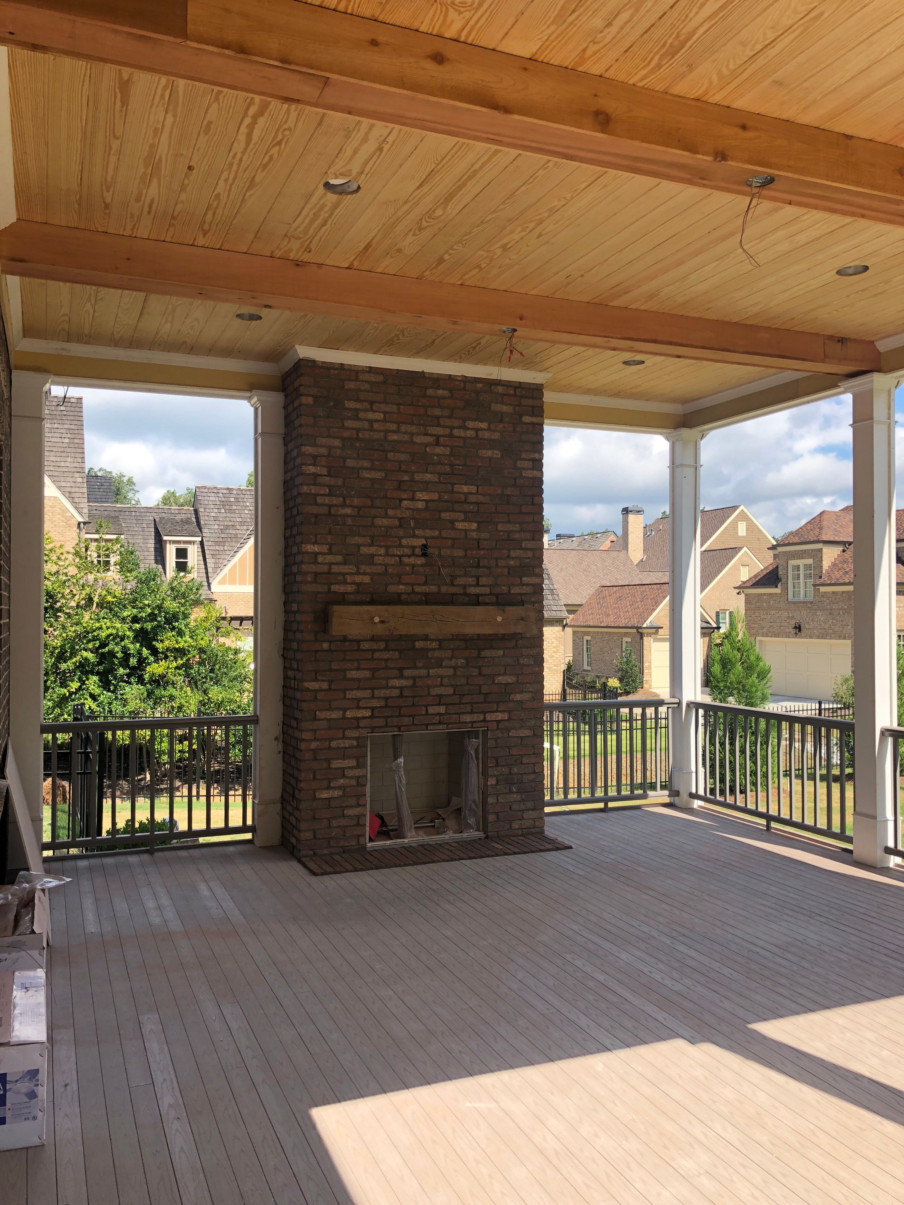 Custom Screened Porch Addition with White Brick Fireplace in Duluth by Swift Home Renovations