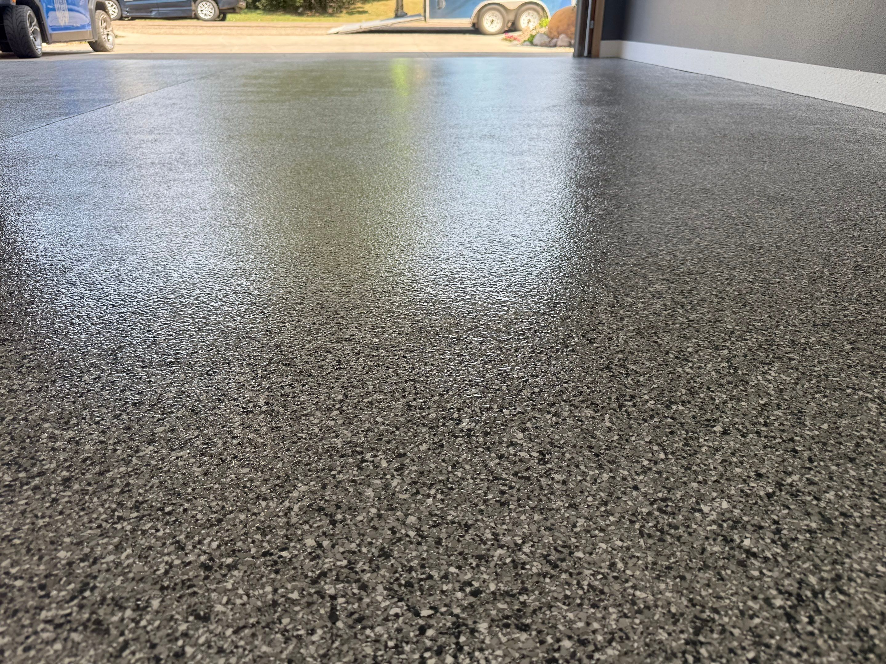 Custom Garage Floor Coating and Backyard Patio Refinishing in Tyndall by Select Painting, Coatings & Garage Cabinets