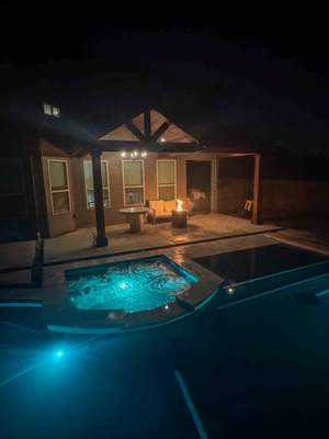 Geometric Pool with Spillover Spa and Dark Interior