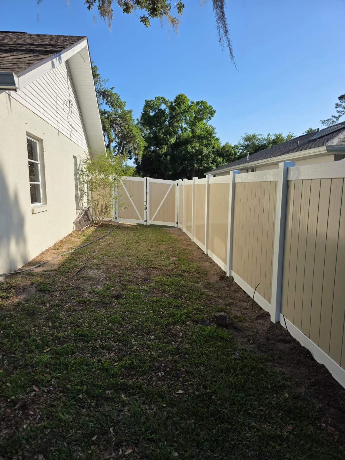 Two-Tone Vinyl Privacy Fence Installation in Port Charlotte by True Fence LLC