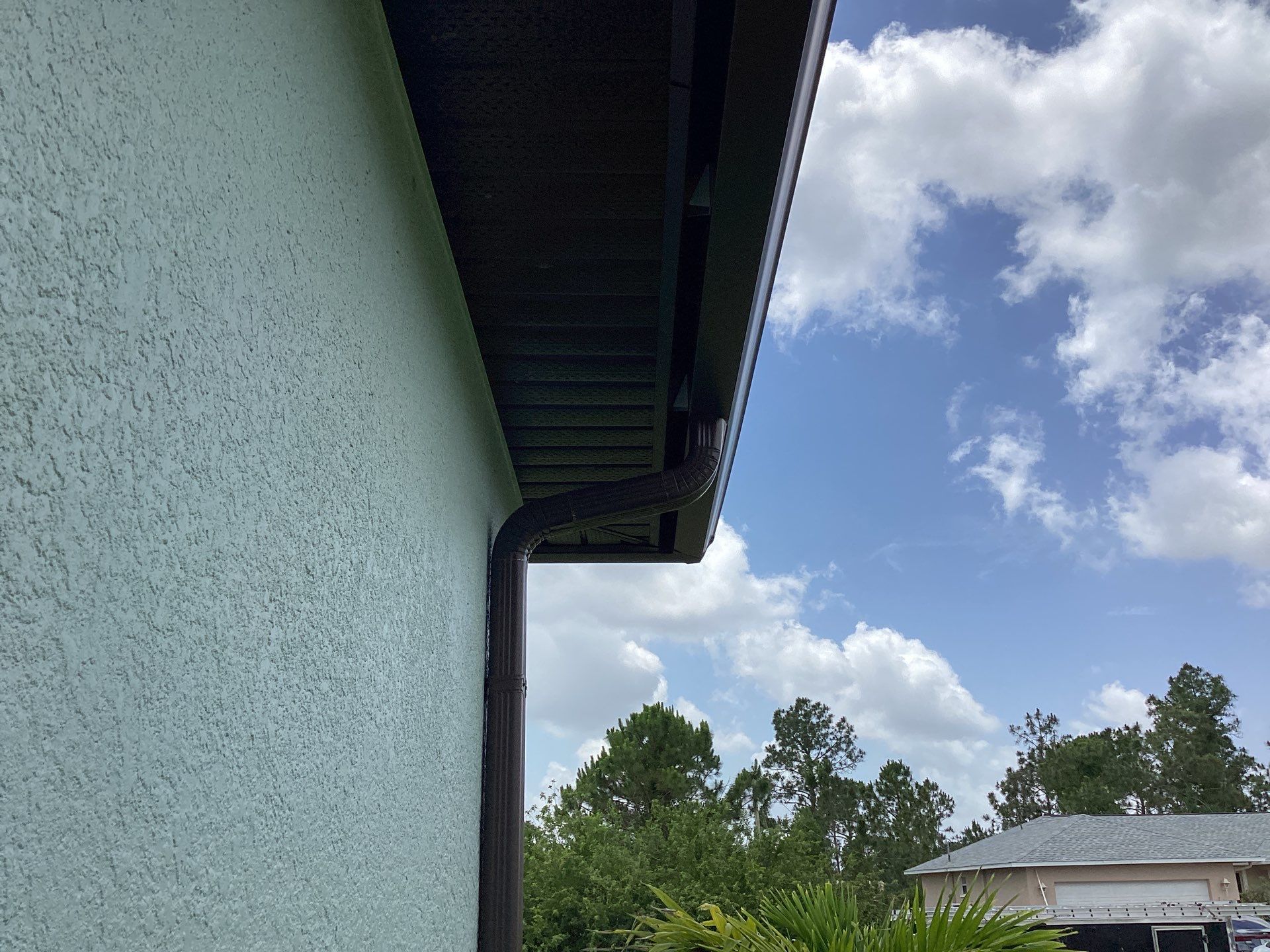 Musket Brown and New Downspouts in Lehigh Acres, FL  by Gutter Professors