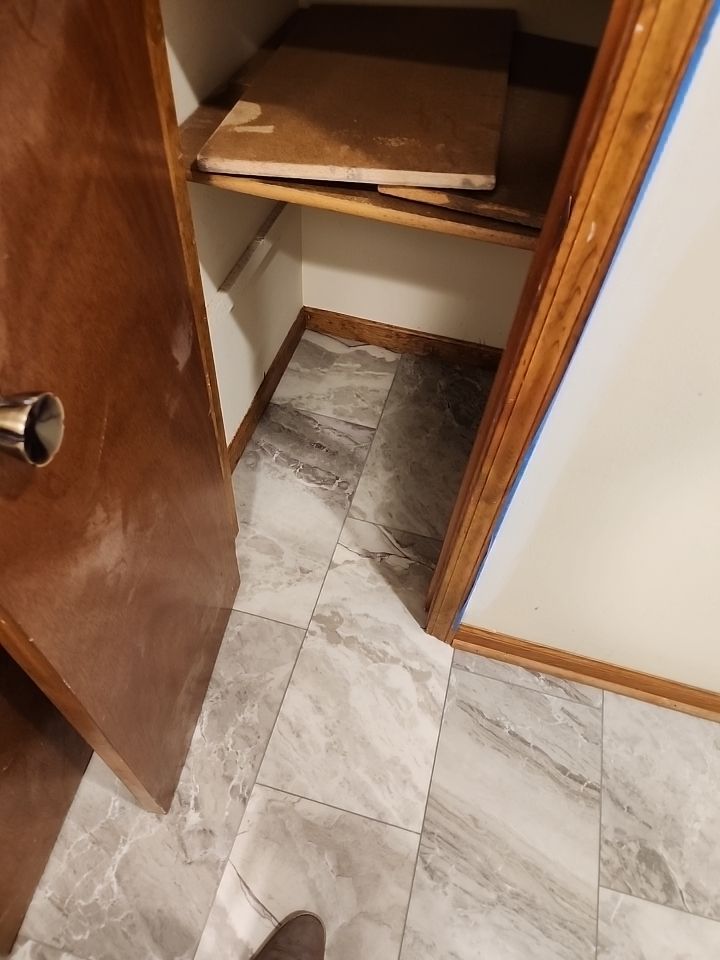 Bathtub, door, toilet, flooring, and countertop by The Shower Company