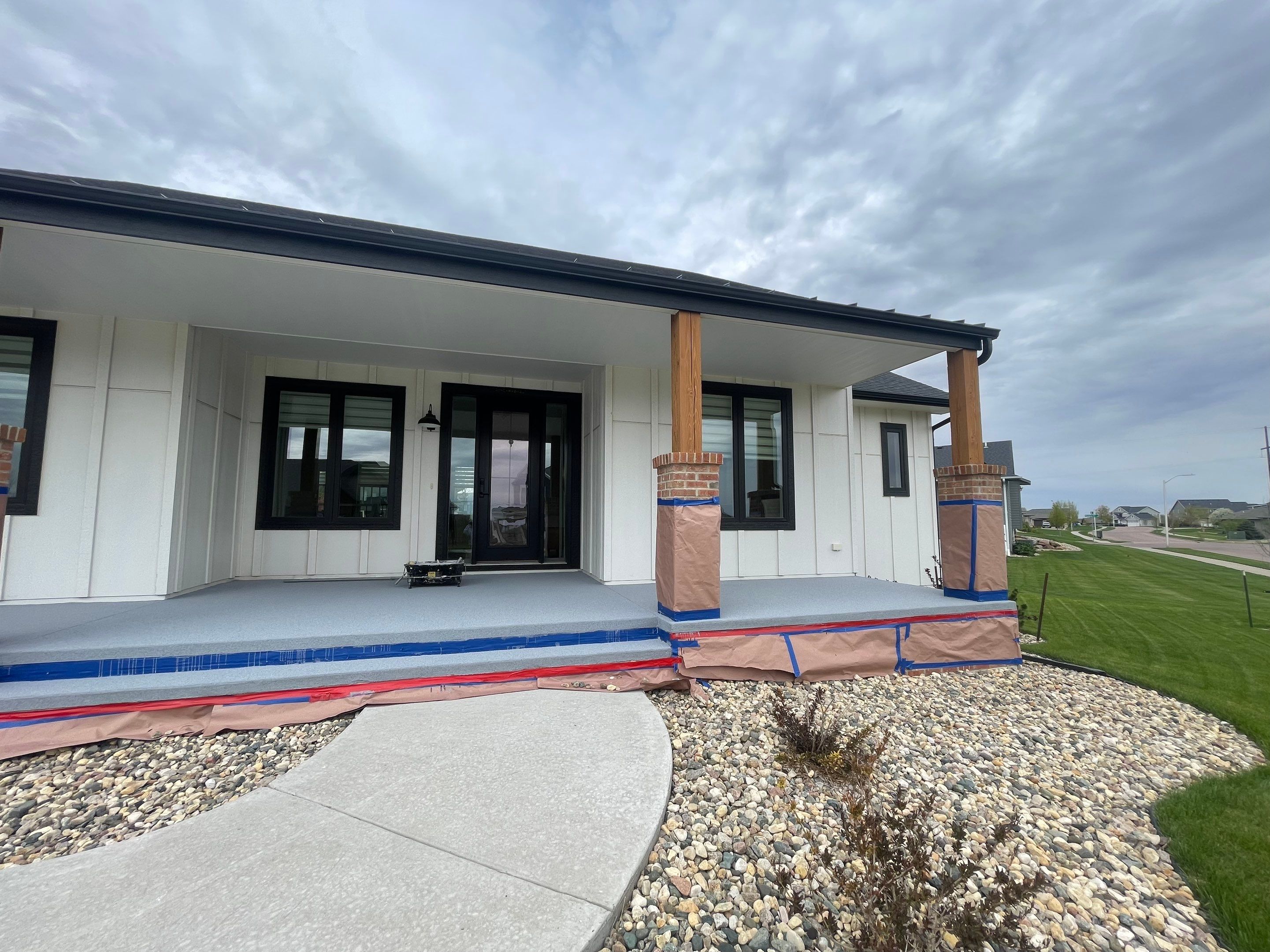 Grey Speckled Concrete Porch Coating for Sioux Falls Home by Select Painting, Coatings & Garage Cabinets
