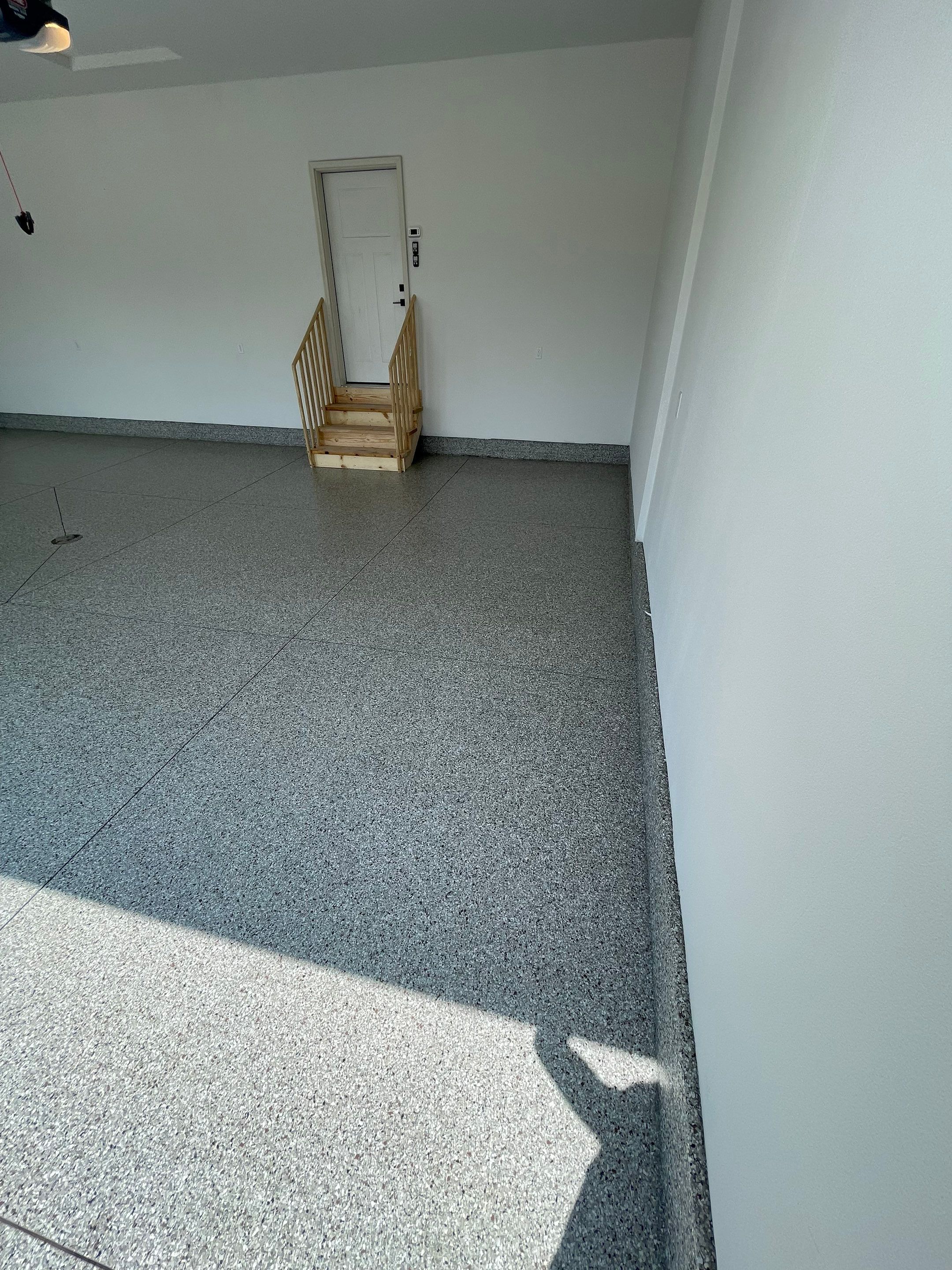 Grey Speckled Garage Floor Coating in Sioux Falls by Select Painting, Coatings & Garage Cabinets