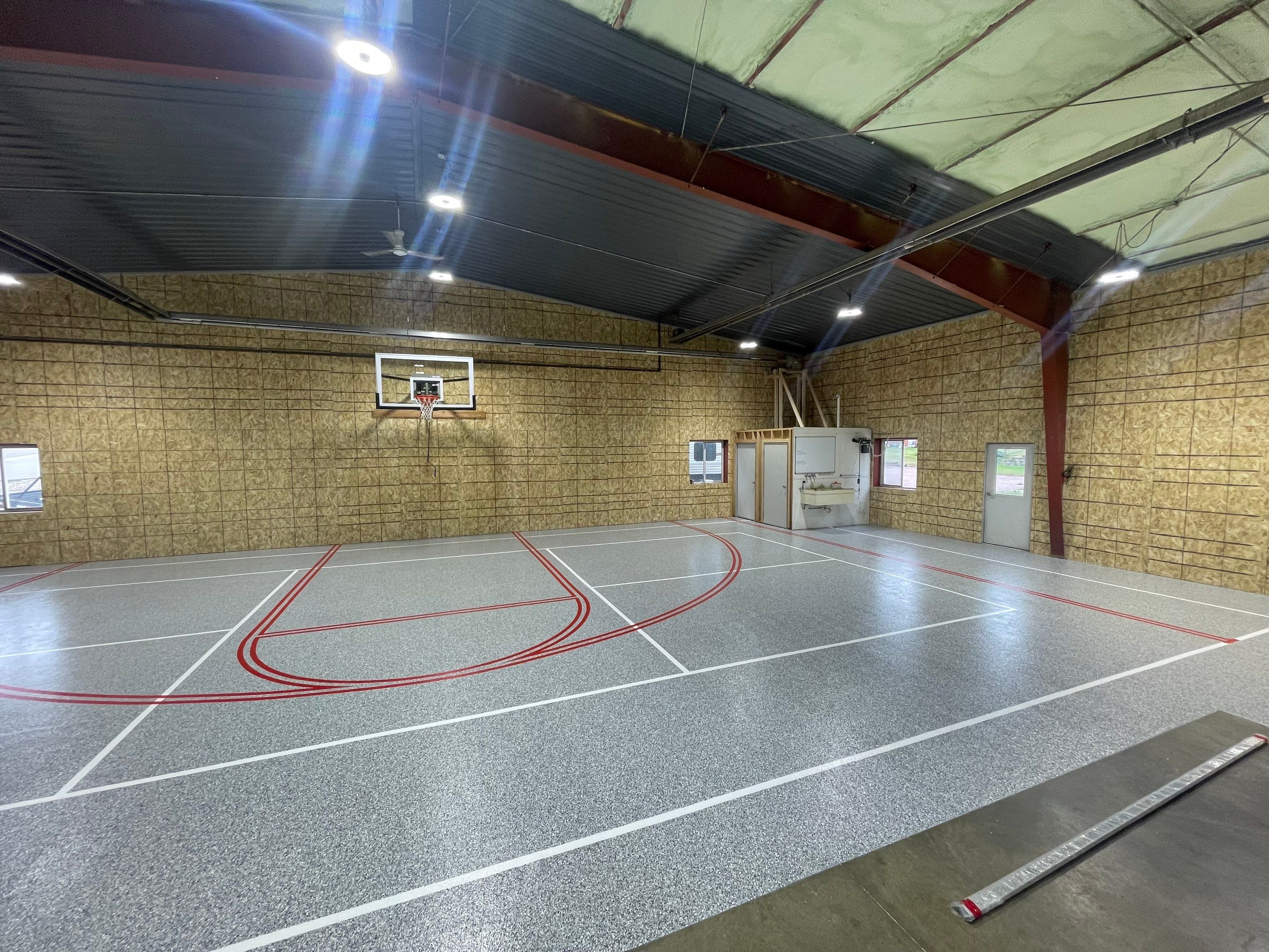 Custom Polyurea Shop Floor with Basketball Court Lines in Rock Valley by Select Painting, Coatings & Garage Cabinets