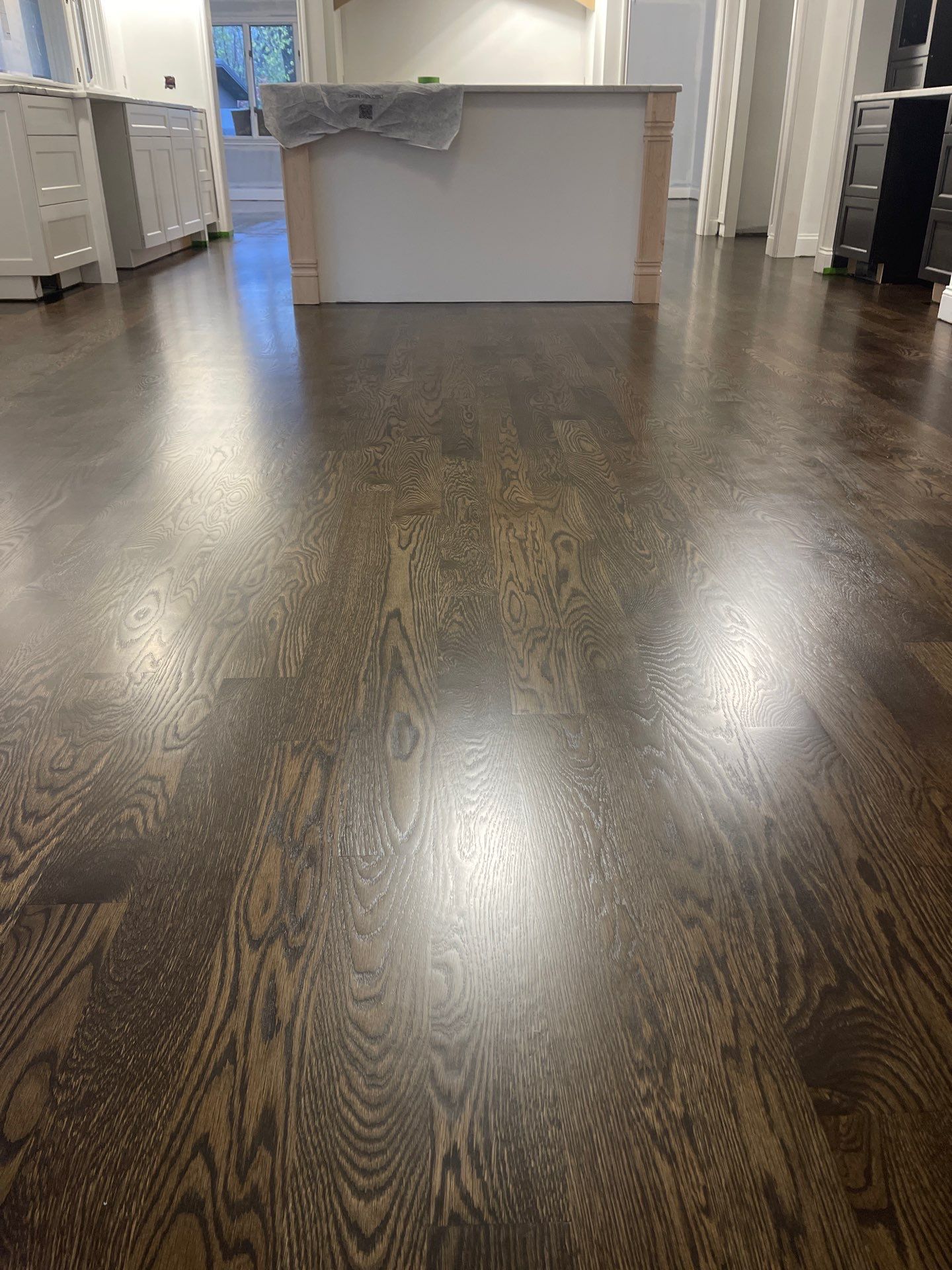 New Flooring installation using 4" White oak select grade plain sawn Ebony Stain by Ann Arbor Hardwoods