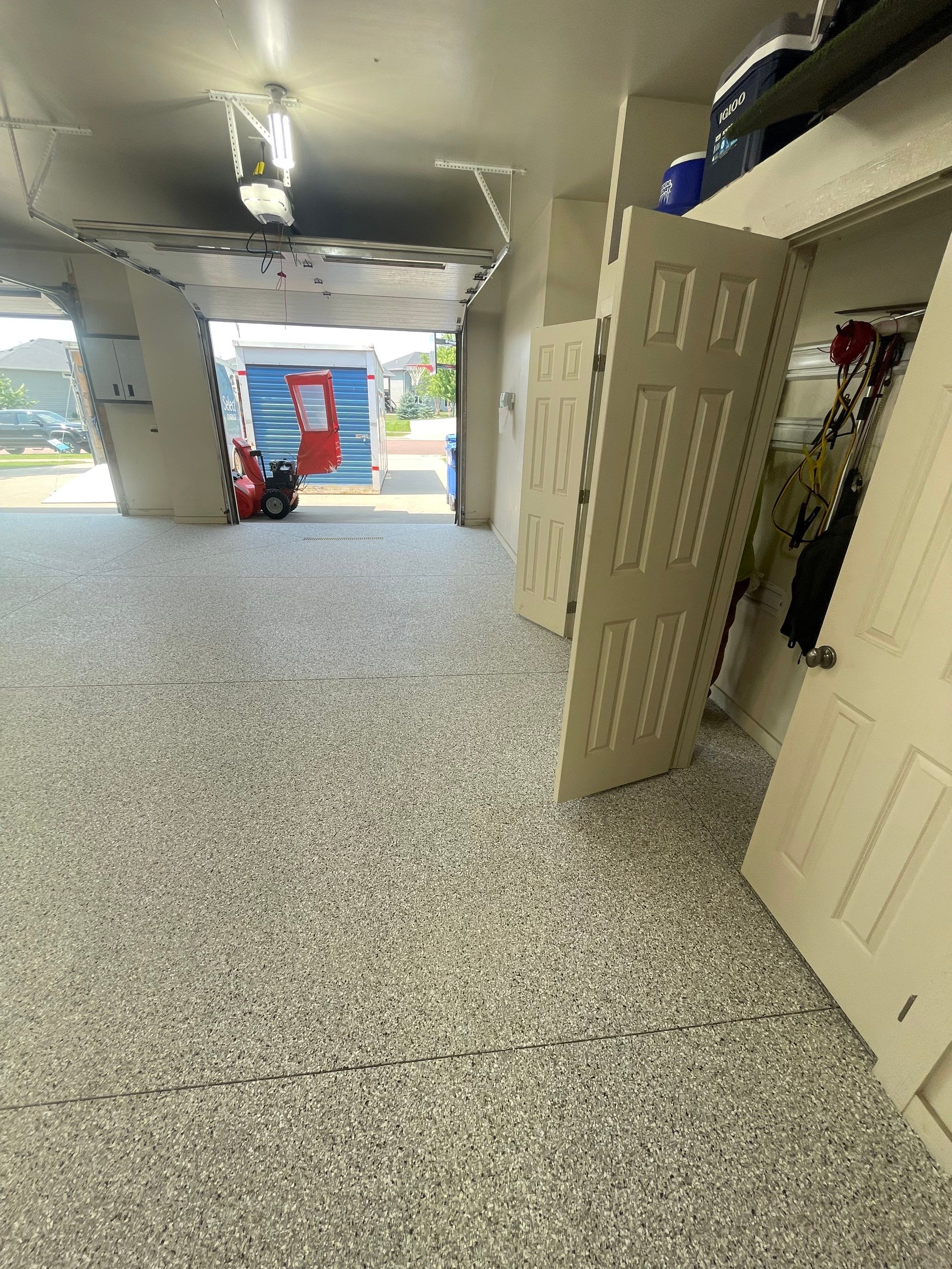 Coyote Flake Garage Floor Coating in Sioux Falls with Trench Drain by Select Painting, Coatings & Garage Cabinets