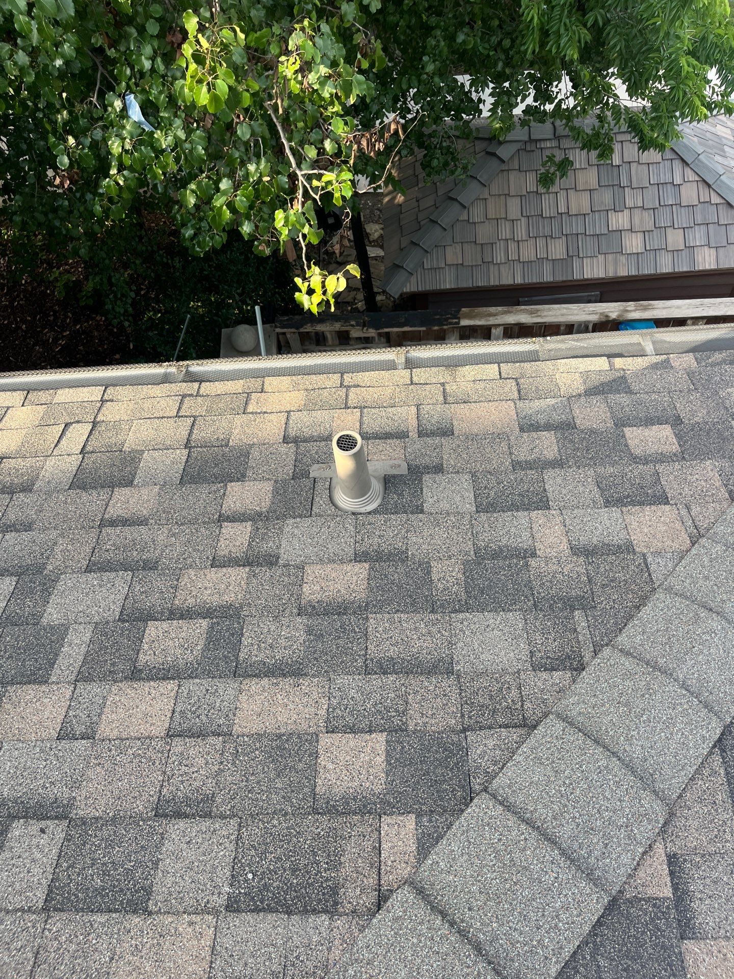 Tan exterior with IKO Driftshake by Tejas Roofworks + Restoration