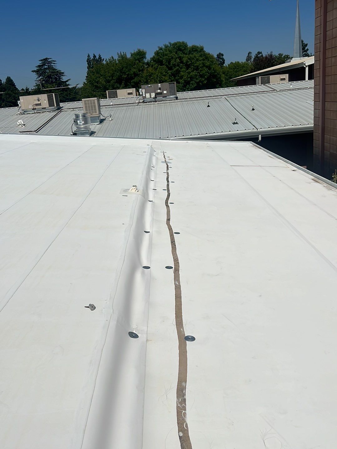MR Roofing system using Benchmark/PUMA XL coatings over TPO single-ply roofing by Straight Edge Roofing Inc