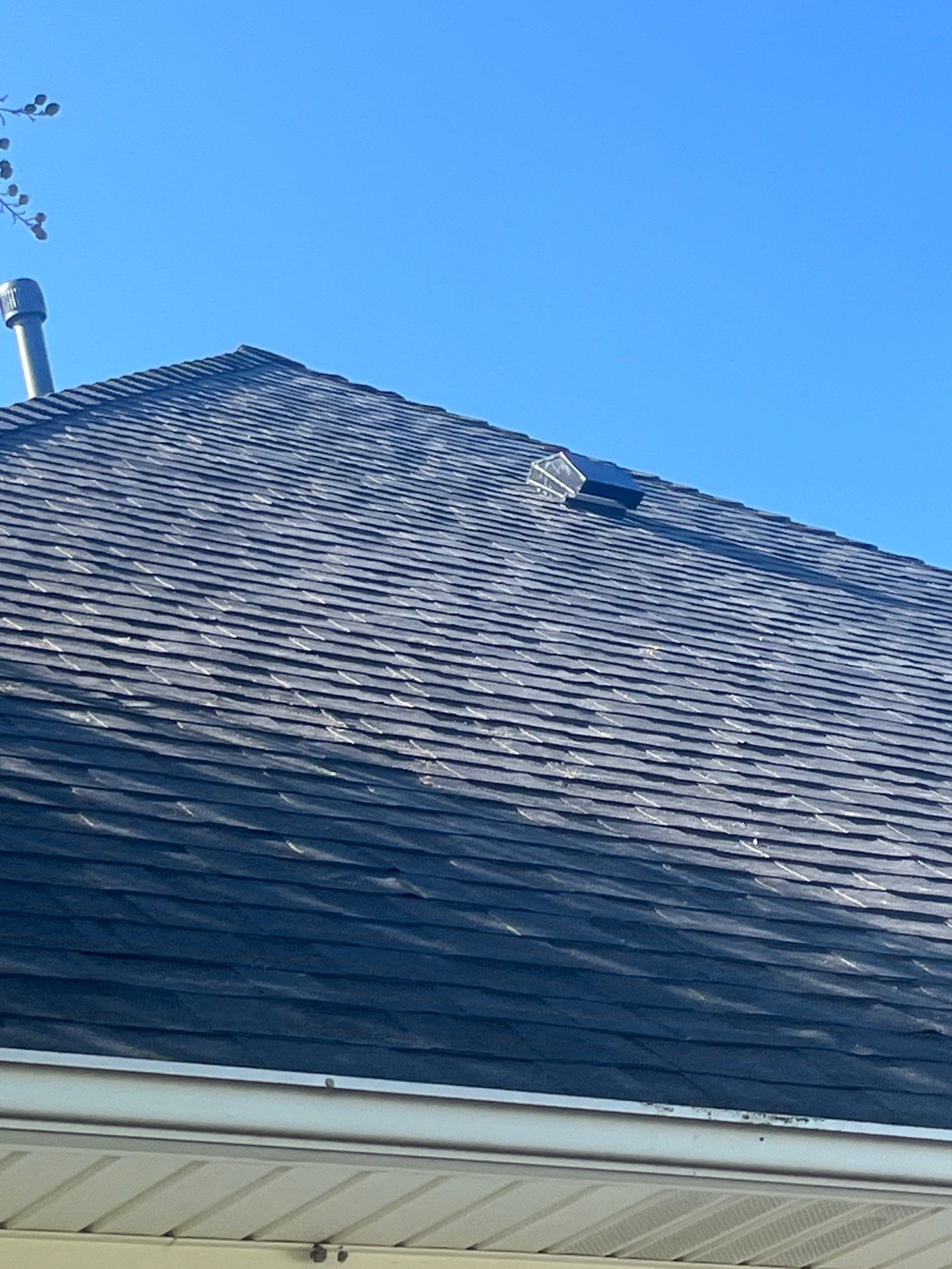 White brick with Malarkey Brilliant Black by Tejas Roofworks + Restoration