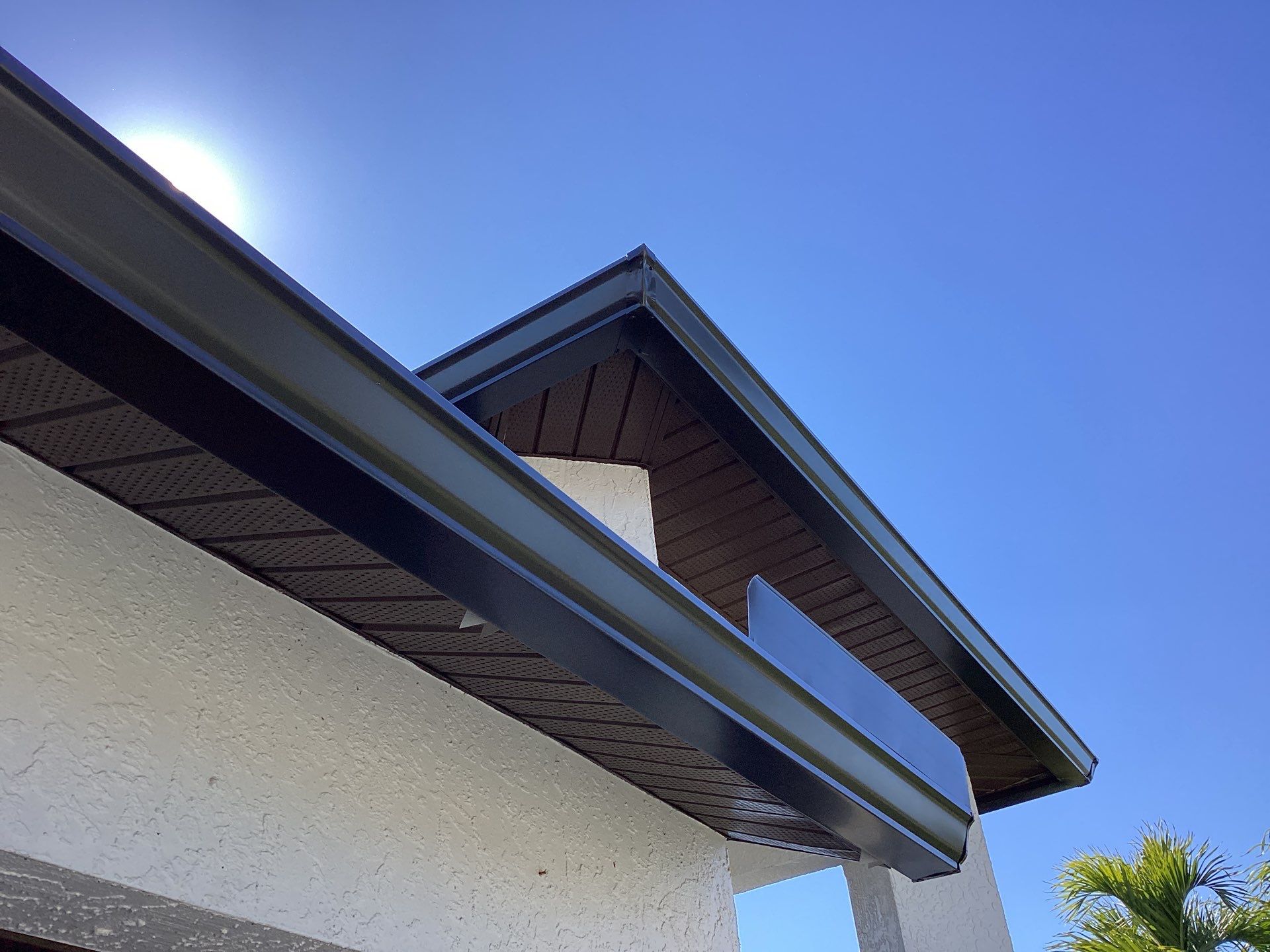 Brown Gutter + White and Brown Downspouts in Cape Coral FL by Gutter Professors