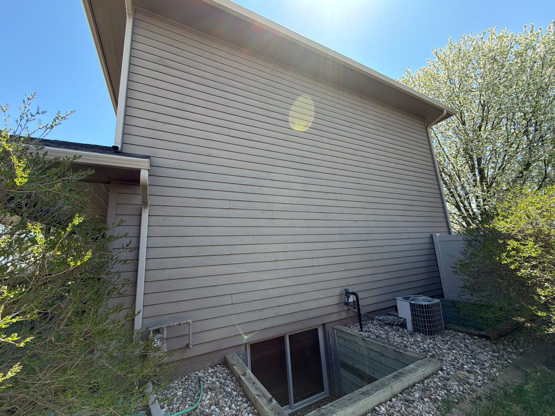 Residential Exterior Painting with Shutter and Trim Updates in Sioux Falls by Select Painting, Coatings & Garage Cabinets