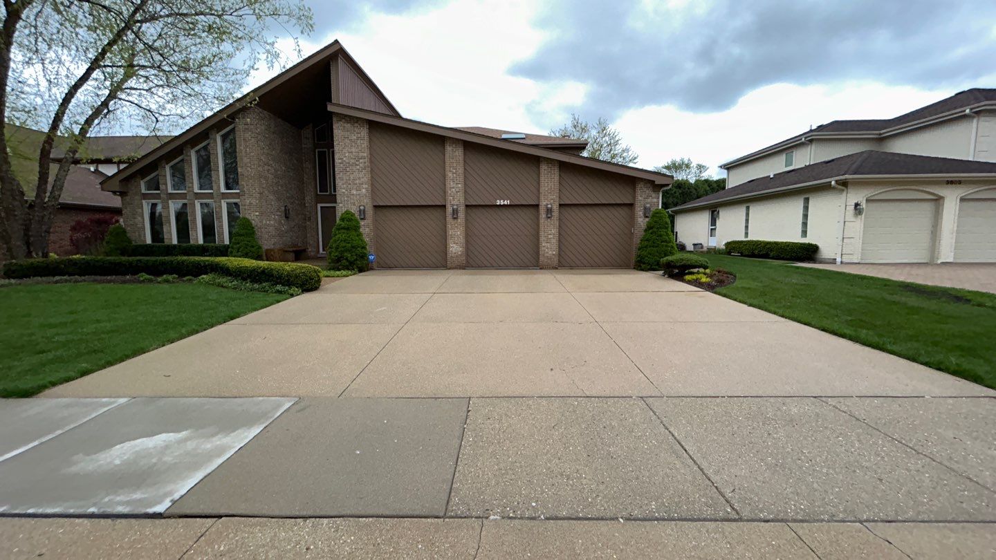 concrete patio and driveway cleaning by Northern Power Washing LLC.