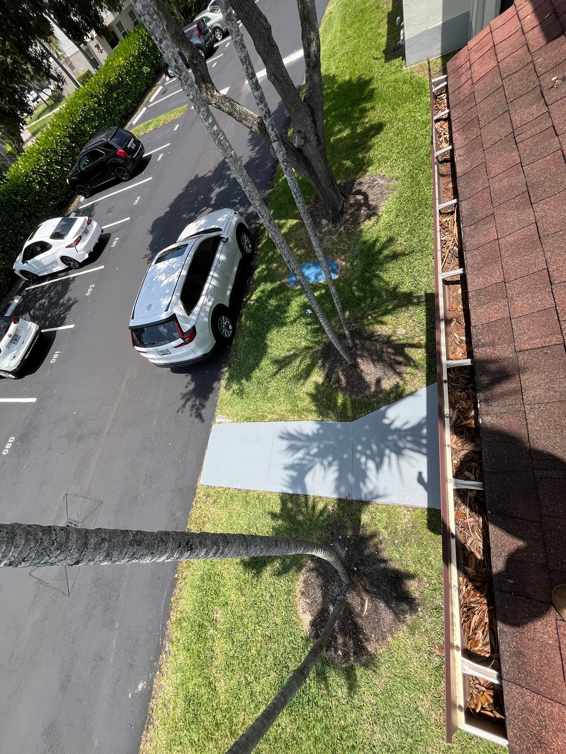 Commercial gutter cleaning Hialeah & Doral, FL before photo with filled gutters