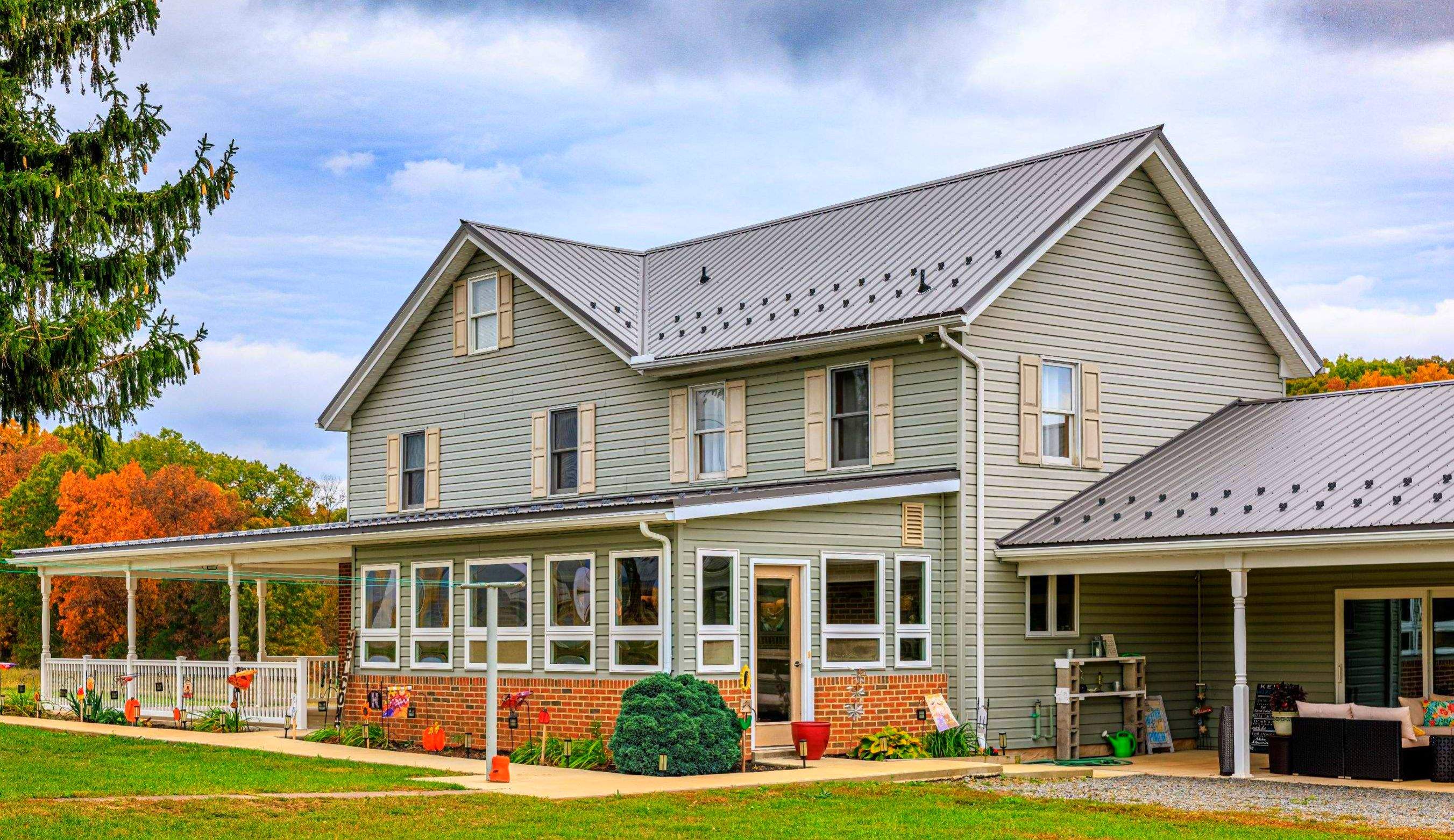 Classic Farmhouse With Textured Charcoal Metal Roof by Esh Builders