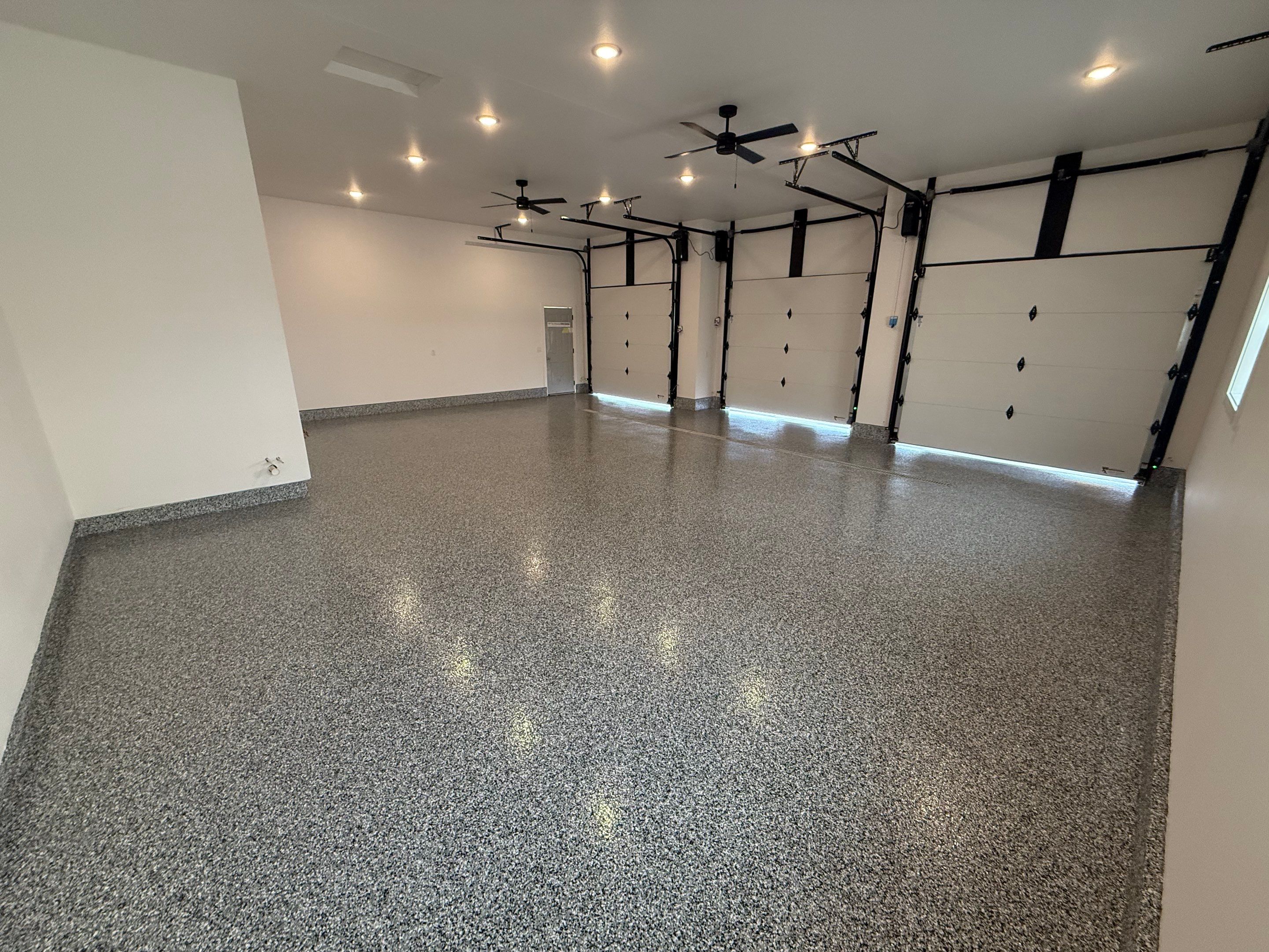 Multi-Car Garage Epoxy Floor Coating and Concrete Finishing in Sioux Falls by Select Painting, Coatings & Garage Cabinets