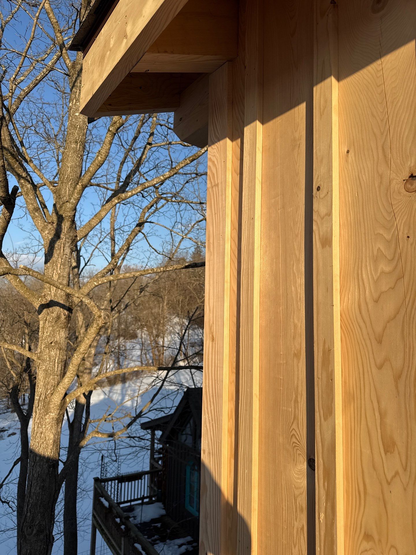 Custom Composite Deck with Stone Fireplace and Modern Cable Railing by Walnut Hollow Decks & Outdoor Living
