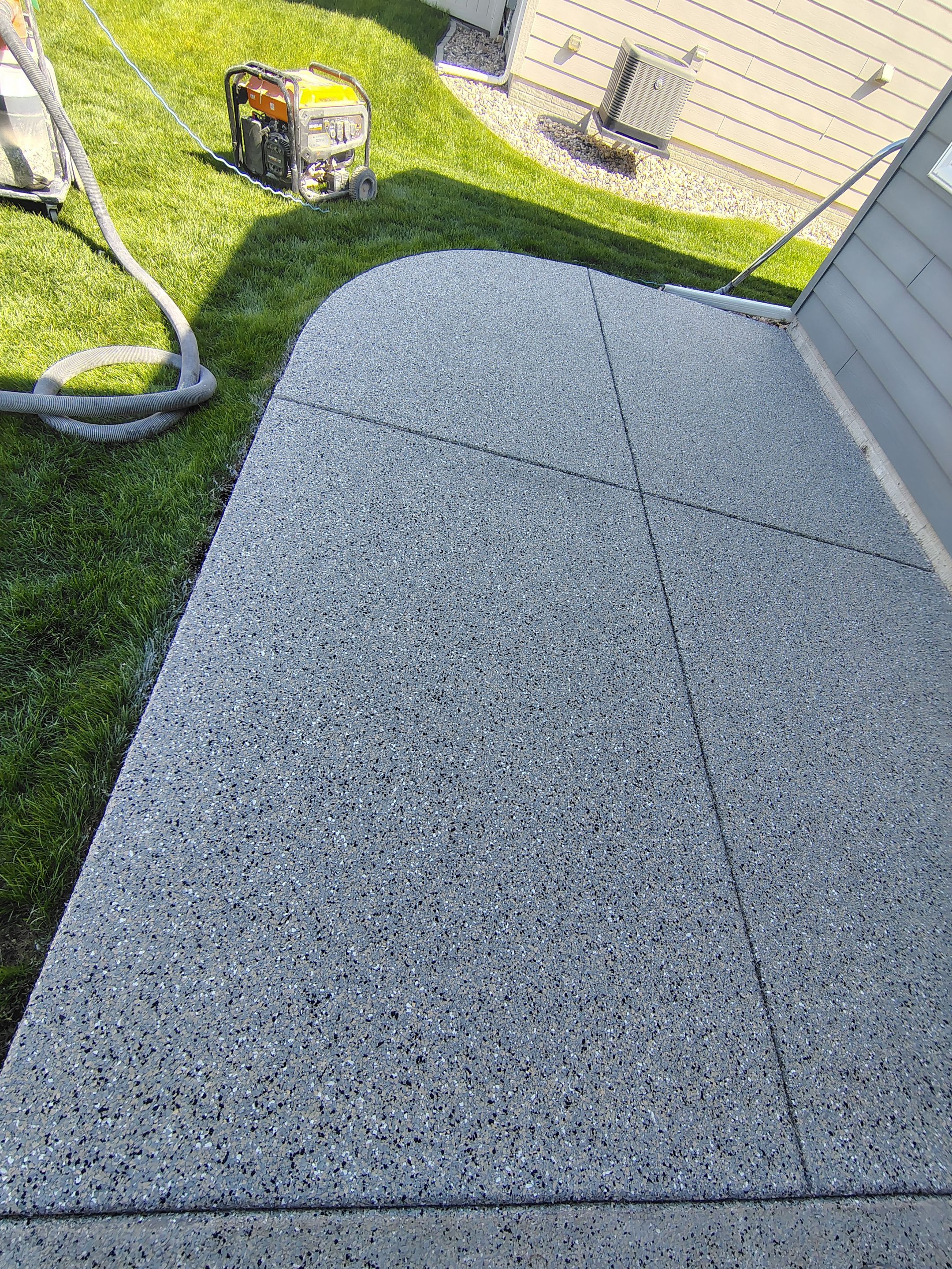 Speckled Concrete Patio Coating Installation in Sioux Falls by Select Painting, Coatings & Garage Cabinets
