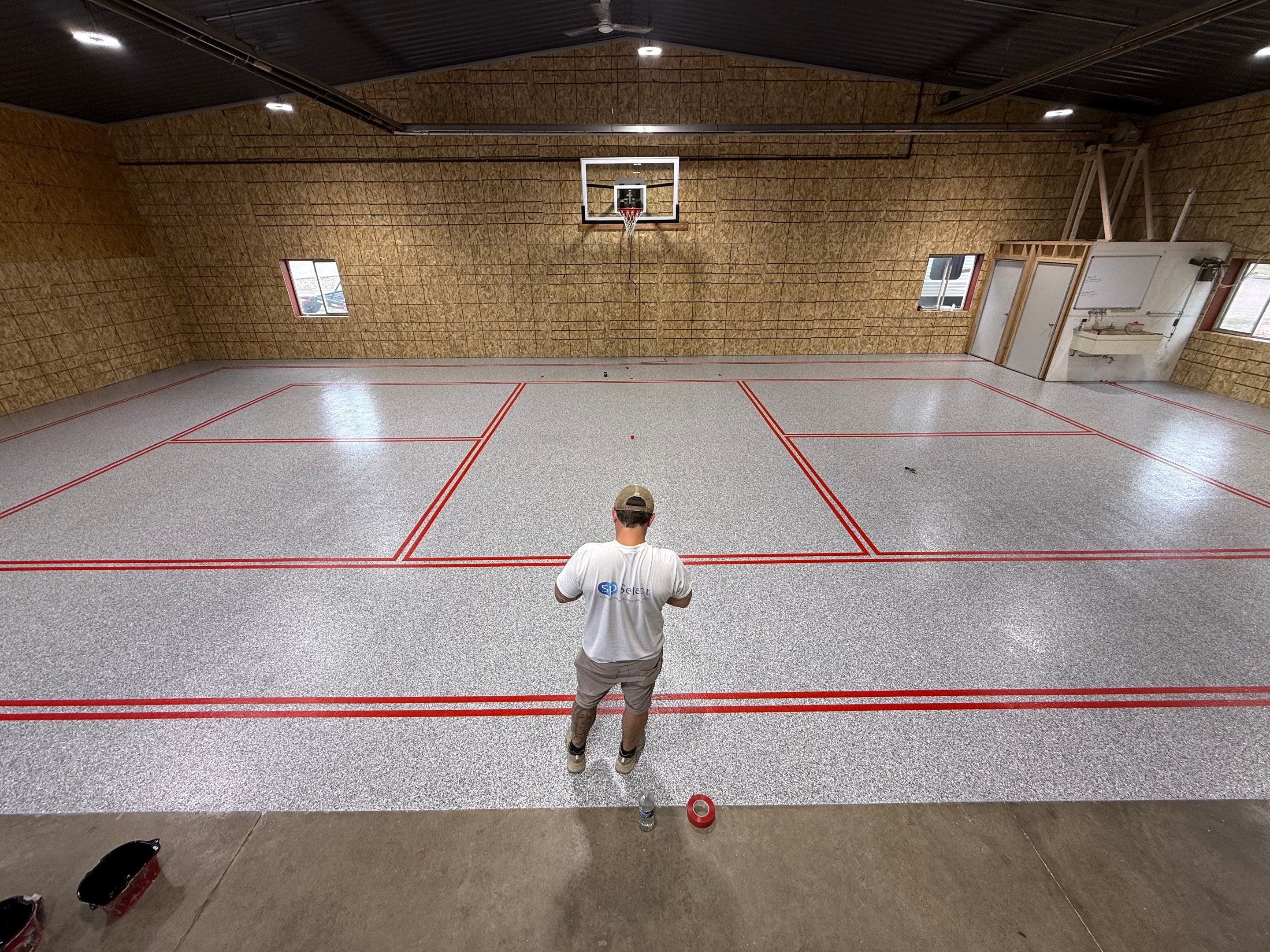 Custom Polyurea Shop Floor with Basketball Court Lines in Rock Valley by Select Painting, Coatings & Garage Cabinets