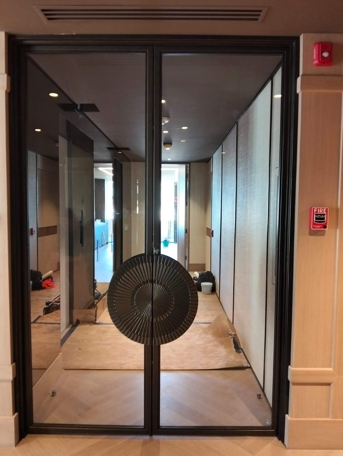 Modern Black Frame Double Door Installation with Custom Radial Hardware by Solara Custom Living