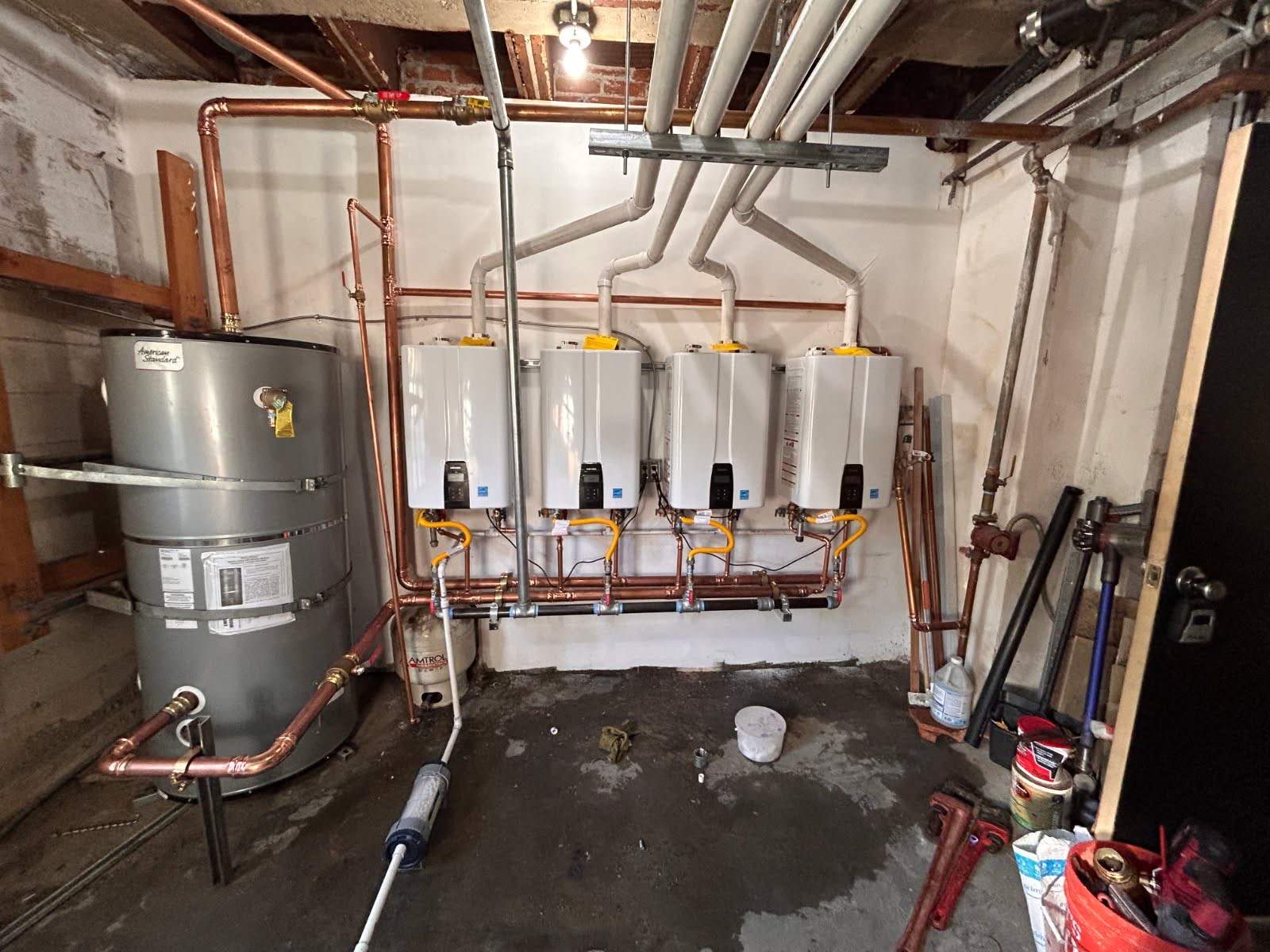 Central Tankless Domestic Hot Water System and Boiler Installation by Current Energy