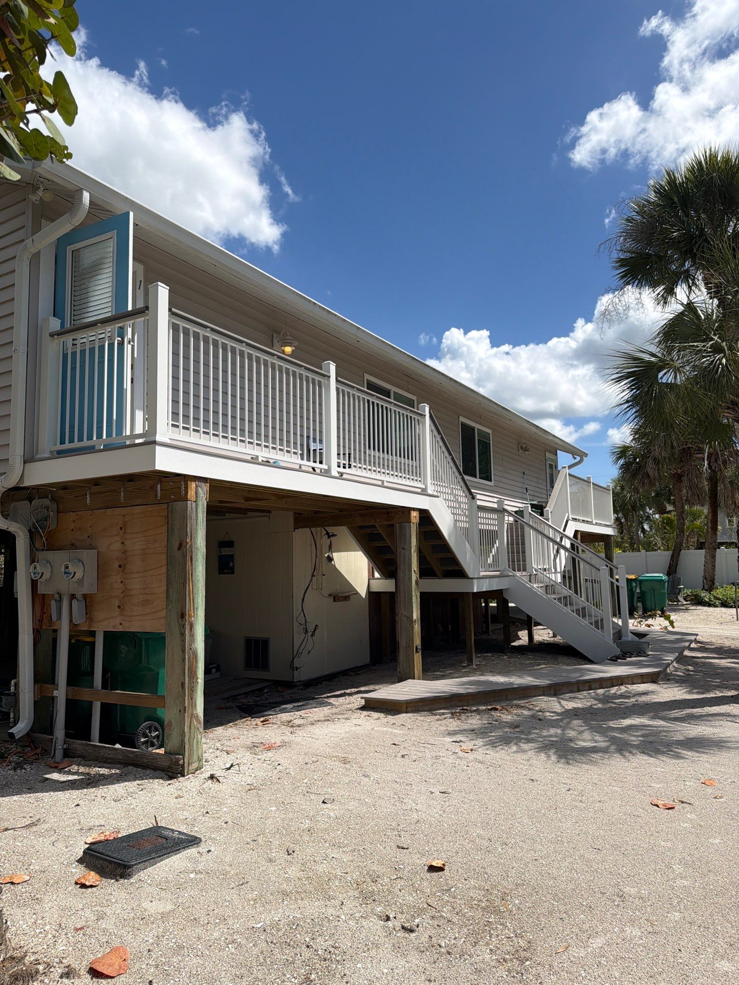 Elevated Home Deck Reconstruction With White Aluminum Railings in Placida by Smirnov Construction Inc