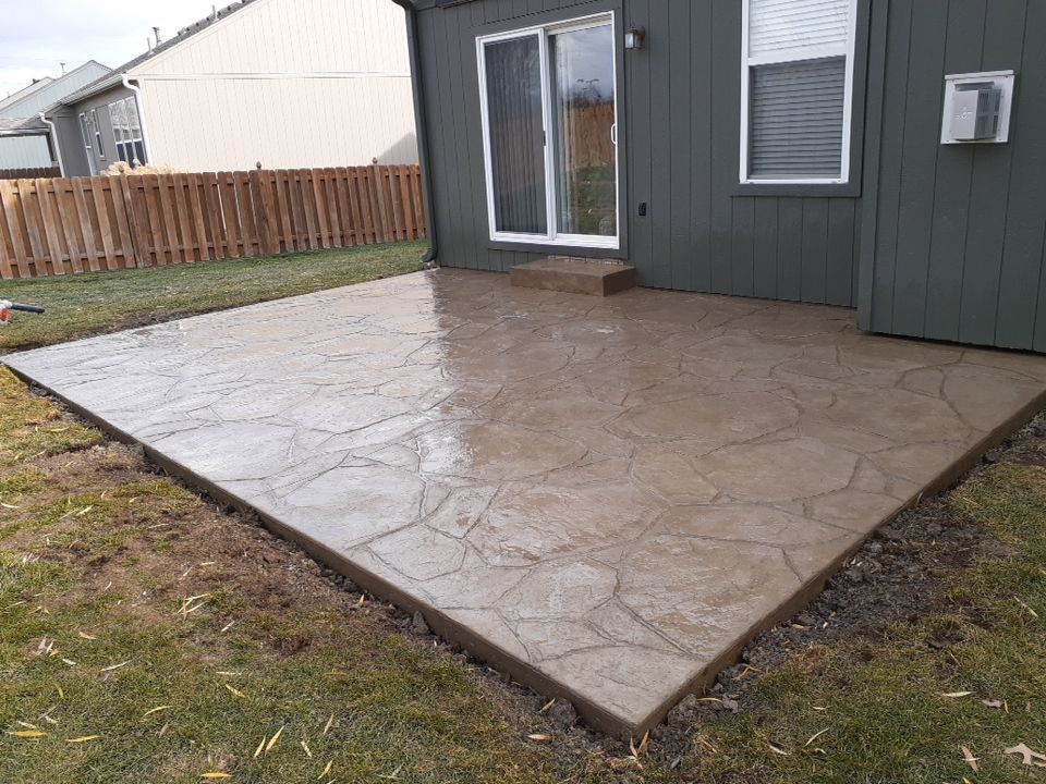 Back Yard Stamped Patio and Pergola by LAND ESCAPES LLC