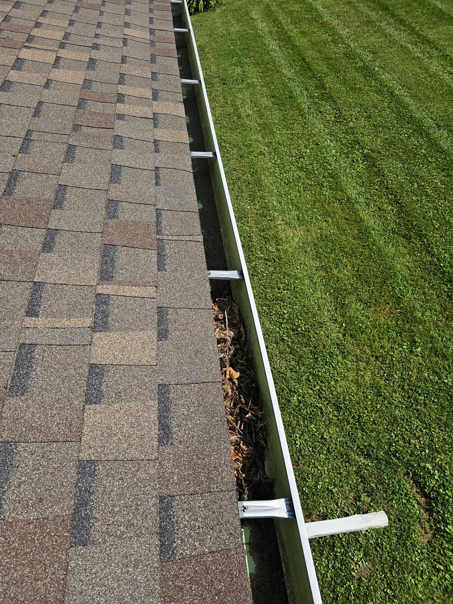 Commercial gutter cleaning Muncie, IN before photo with filled gutters