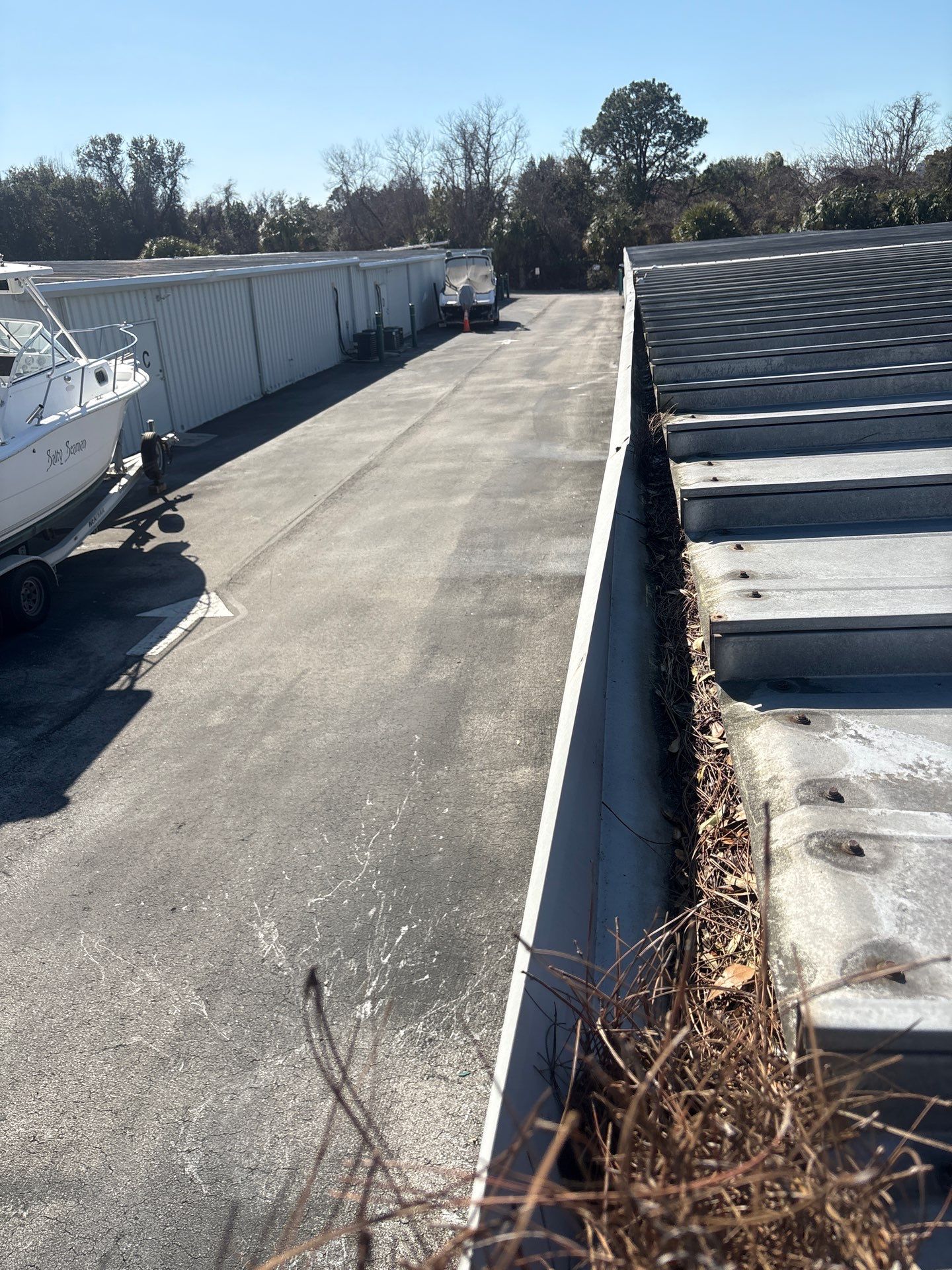 HOA gutter cleaning in St. Johns County & Ponte Vedra, FL,before photo showing full gutters.