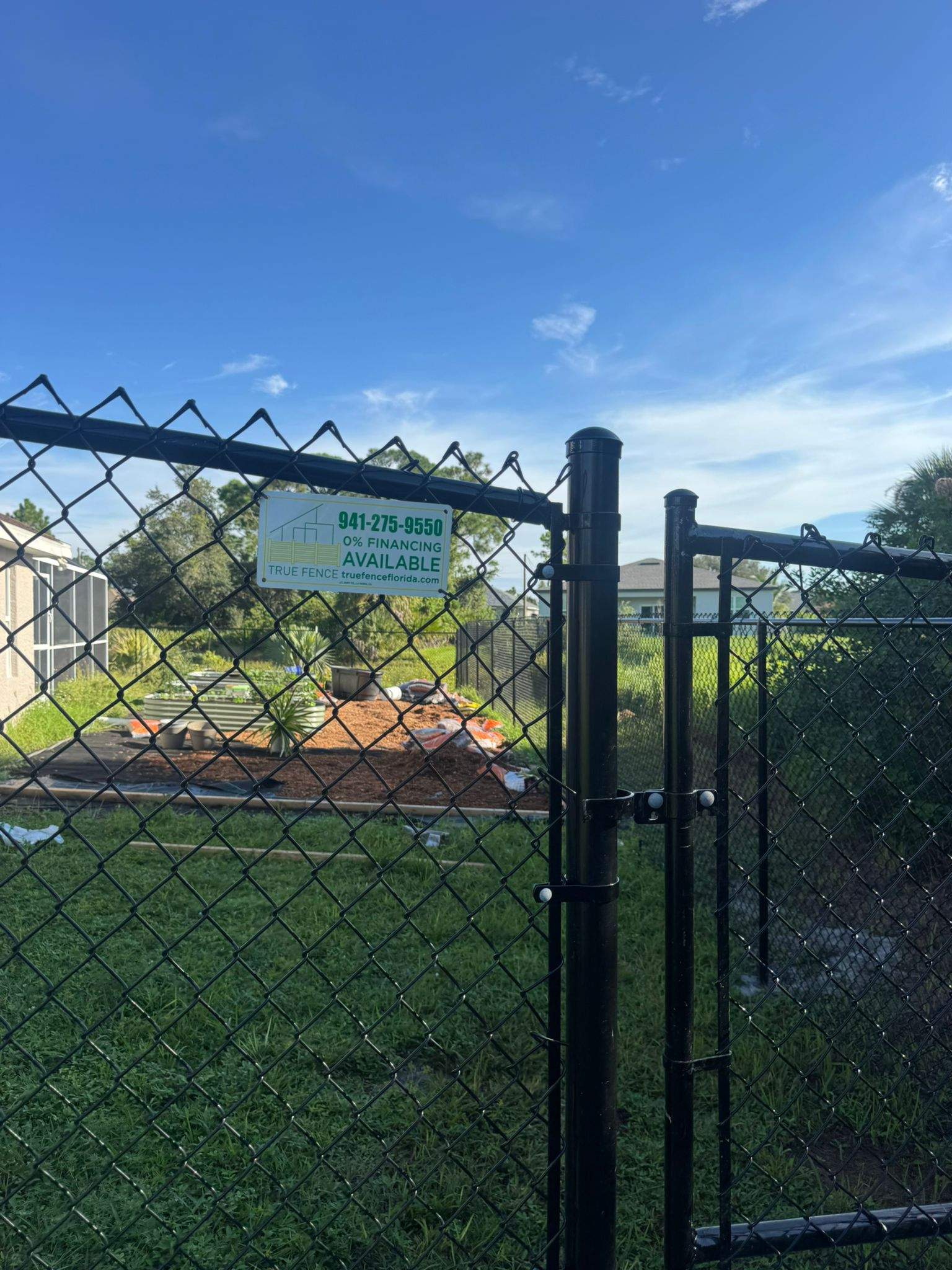 Black Vinyl-Coated Chain Link Fence and Gate Installation in North Port by True Fence LLC