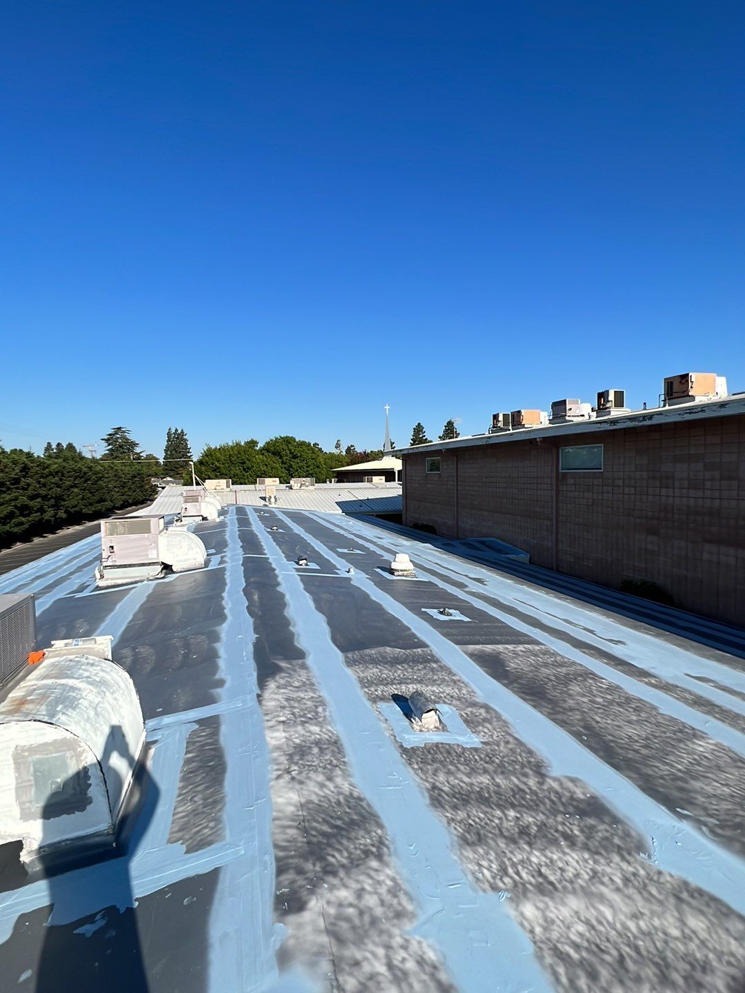 MR Roofing system using Benchmark/PUMA XL coatings over TPO single-ply roofing by Straight Edge Roofing Inc